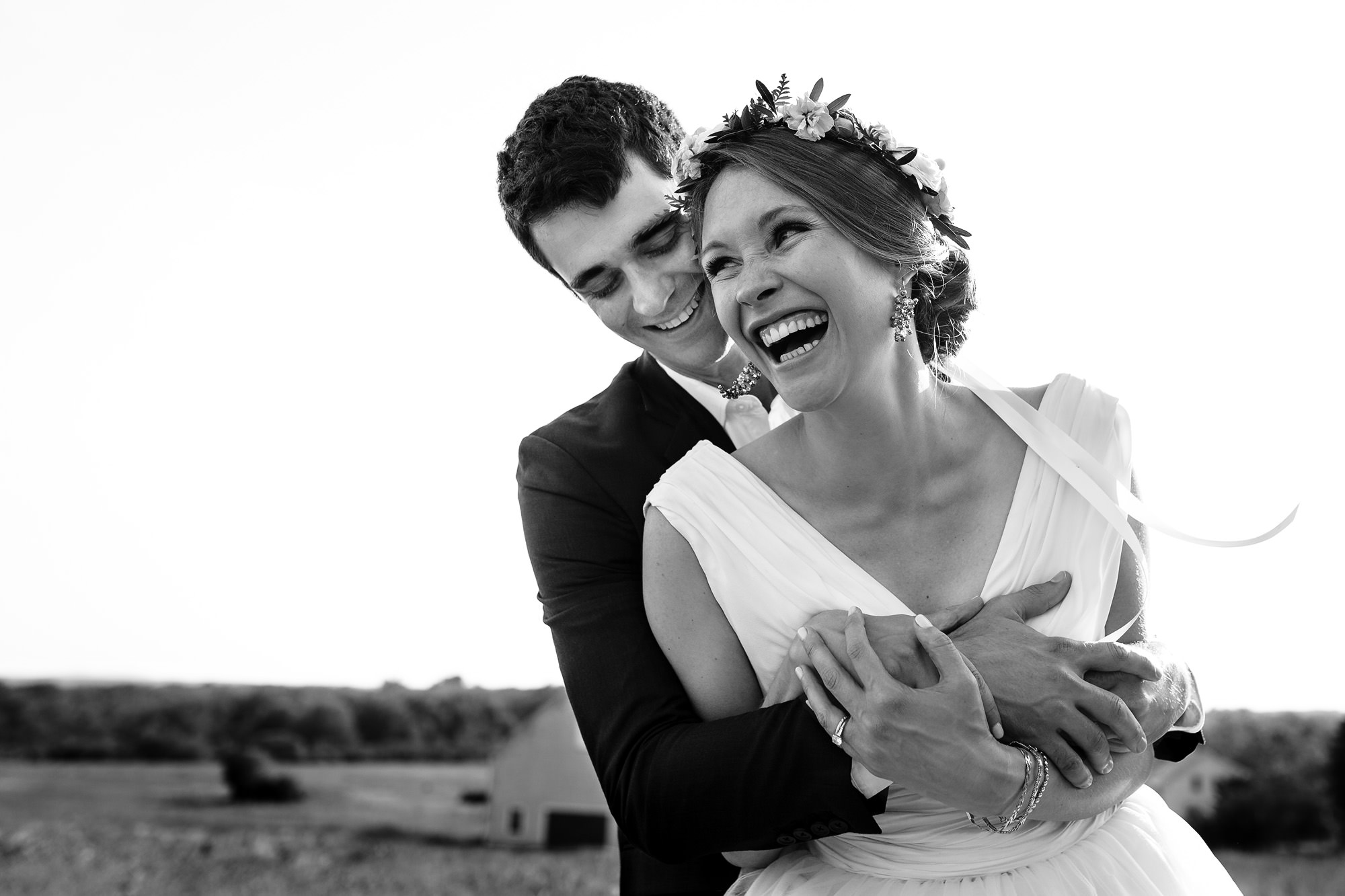 A playful portrait of a bride and groom on their wedding day in Wells, Maine