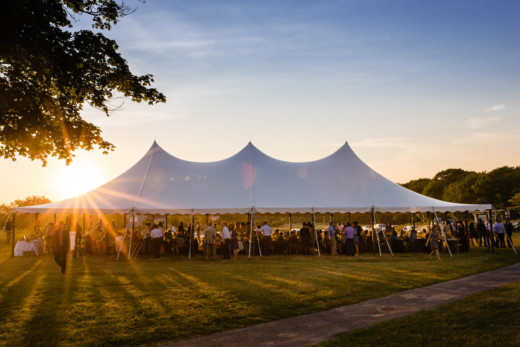 The sun sets at a wedding on the Laudholm Farm tent in Wells, Maine