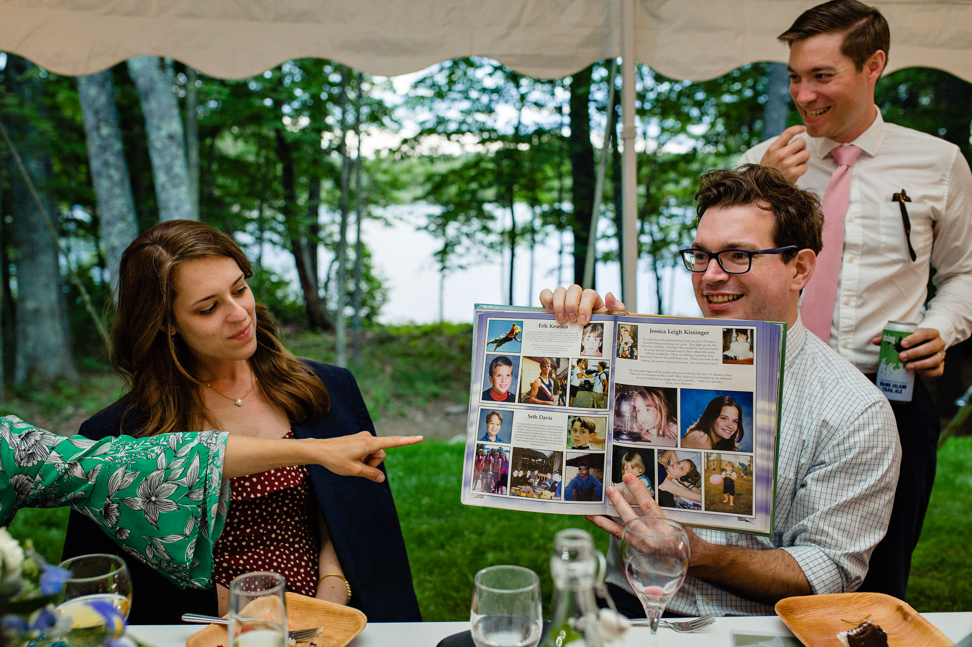 Guests make fun of the groom's yearbook at his wedding in Maine