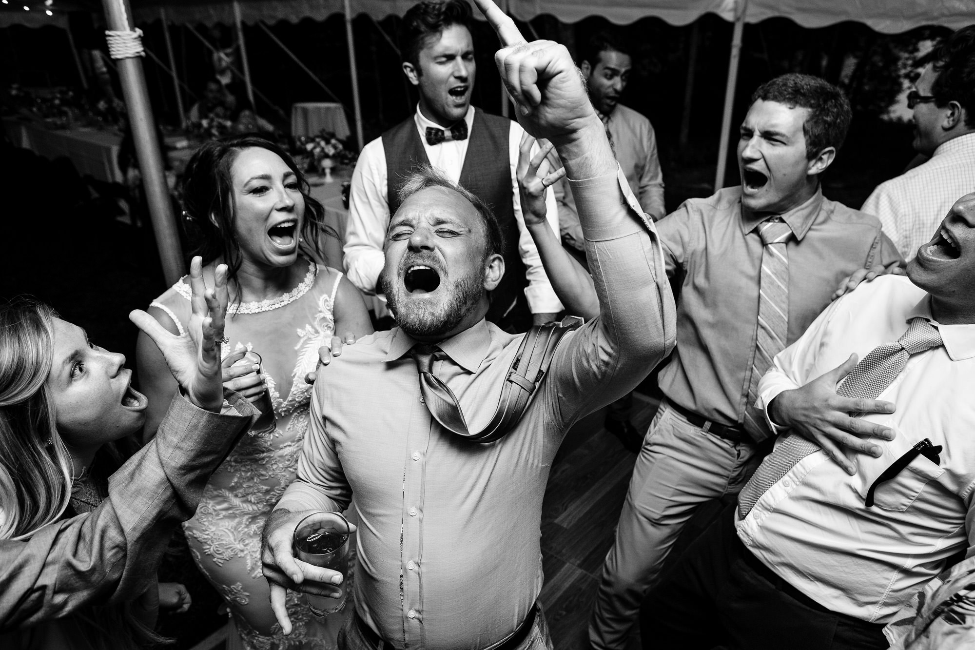 A documentary photo of an energetic Maine wedding dance floor.