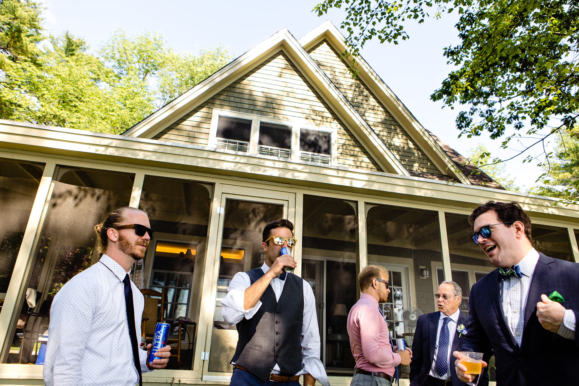 Groomsmen prepare for a lakeside wedding in Maine