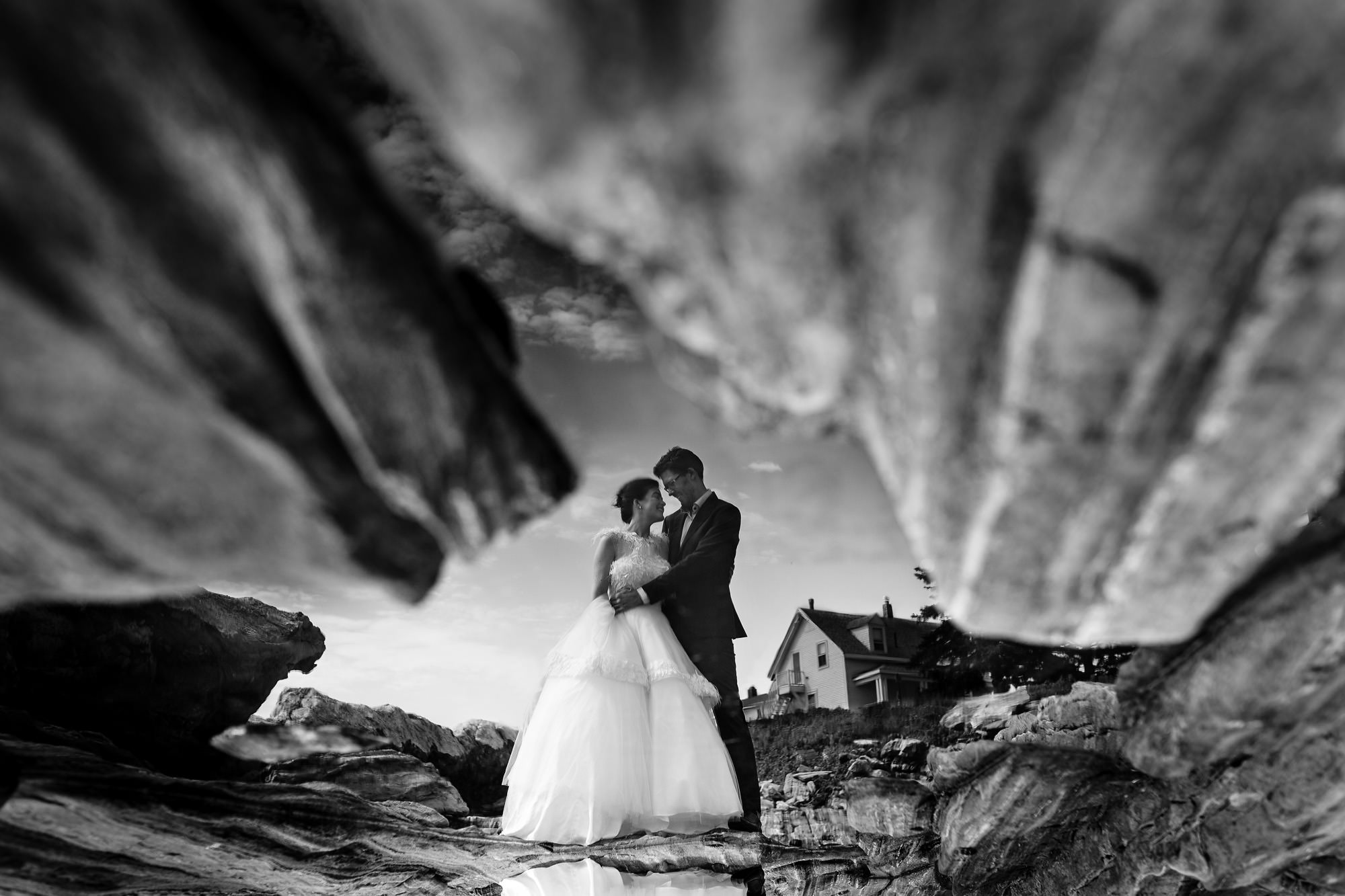 A bride and groom take wedding portraits at Pemaquid Point Lighthouse in Maine