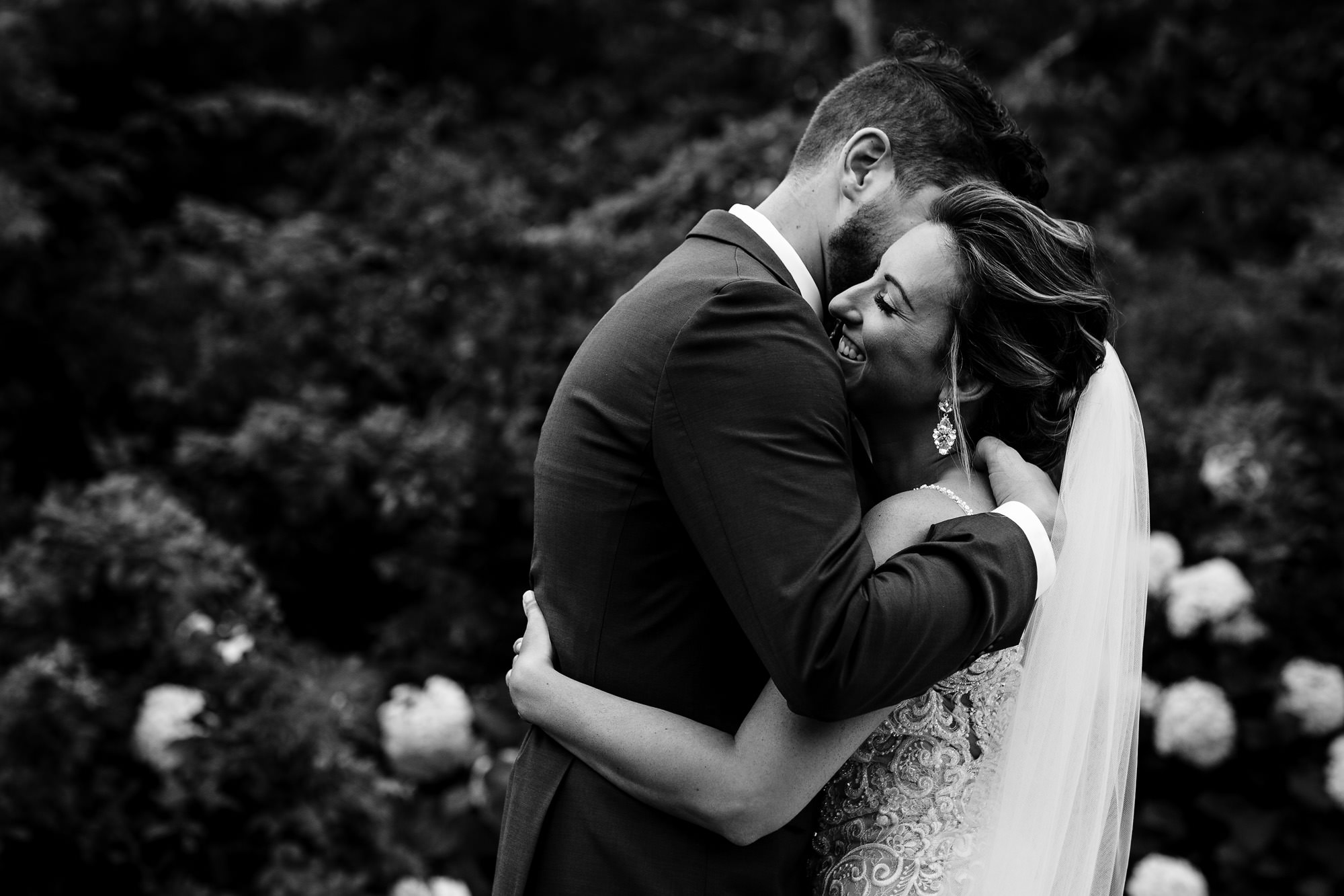 A bride and groom share an emotional hug during their first look at Bradley Inn in Maine