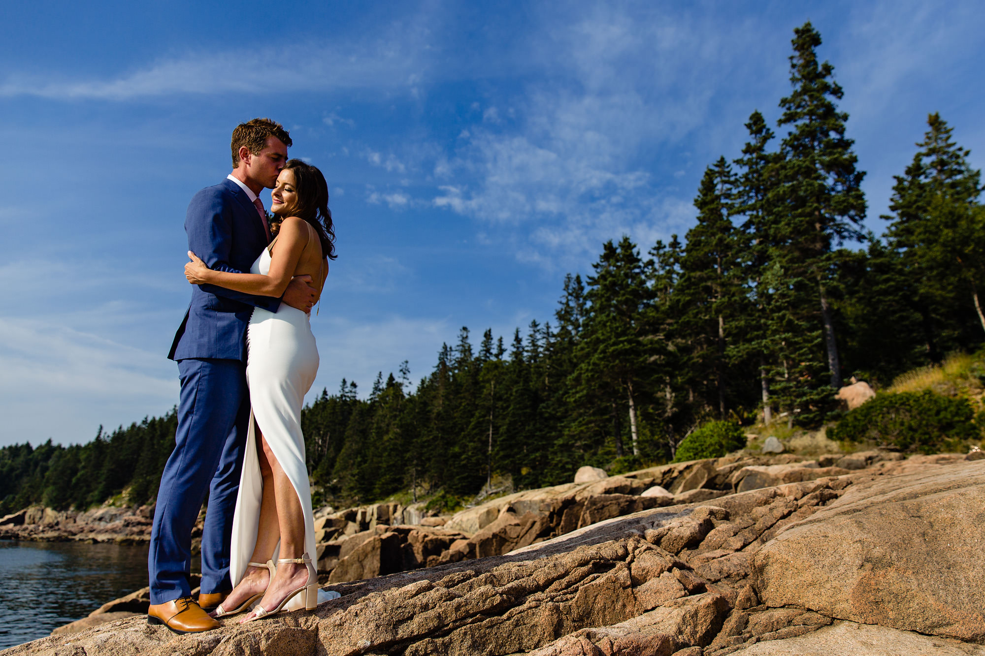 A portrait of a bride and groom at Otter Point in Acadia National Park