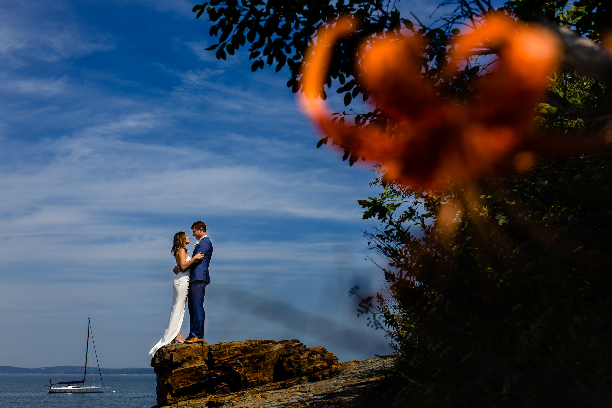 A bride and groom portrait taken on the shore path in Bar Harbor, Maine