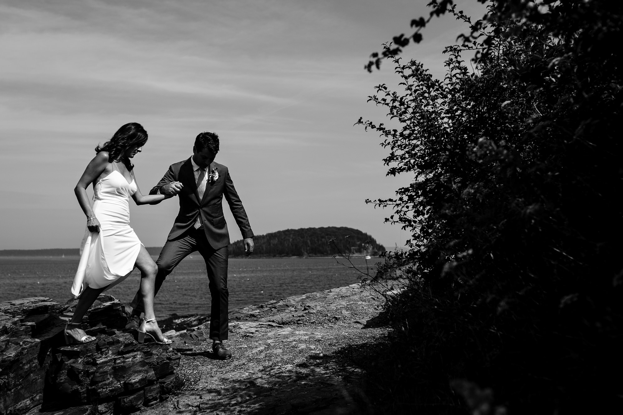 A bride and groom portrait taken on the shore path in Bar Harbor, Maine