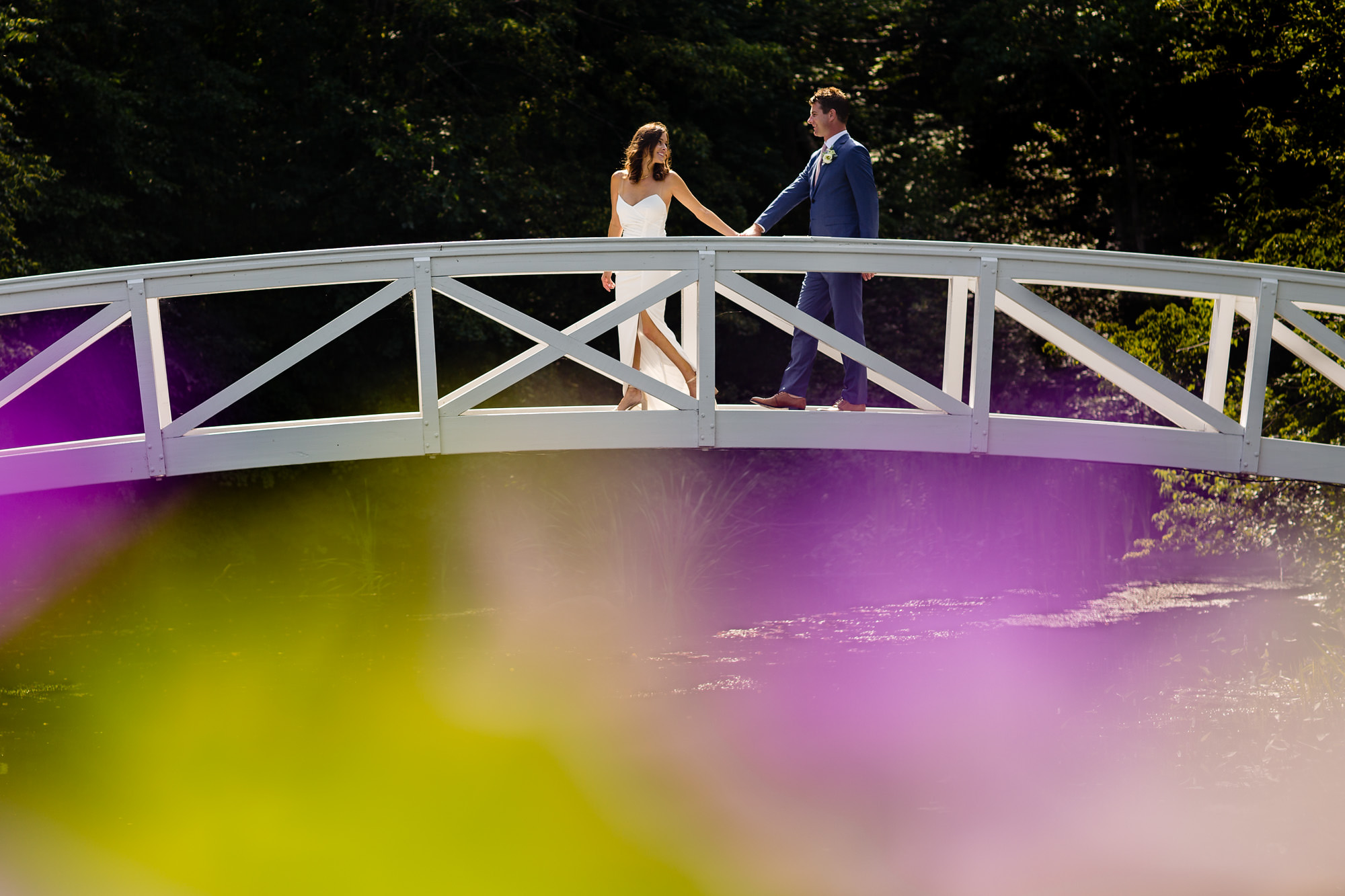 A bride and groom at the Somesville bridge for their elopement in Acadia National Park