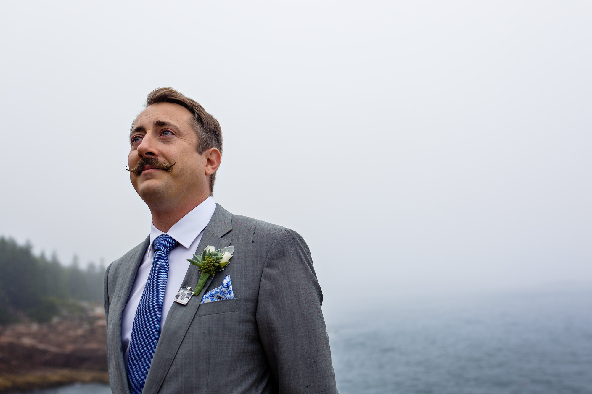 A groom watches his bride arrive to his Acadia National Park elopement ceremony.