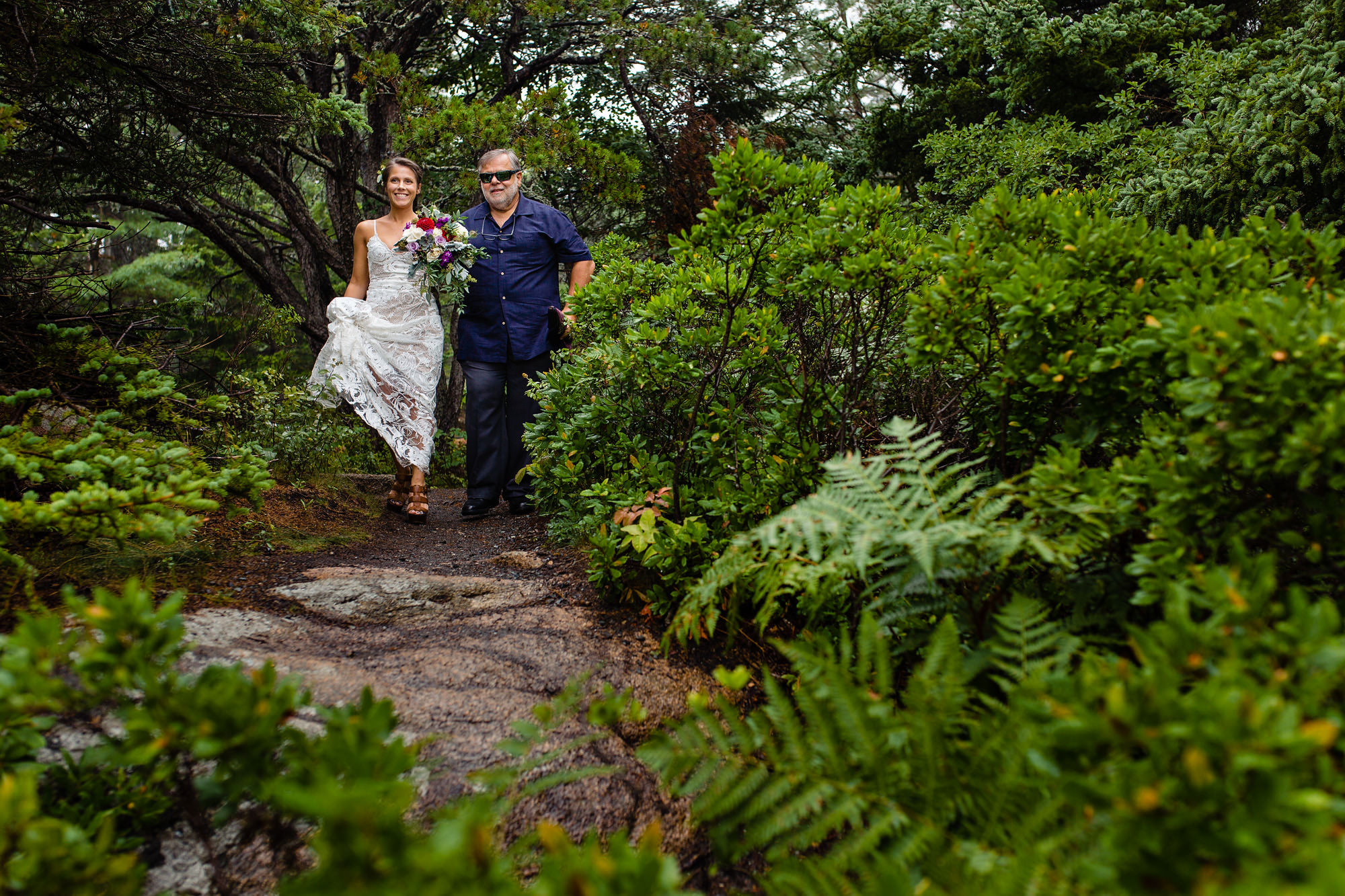 A bride walks with her father to her Acadia national Park elopement