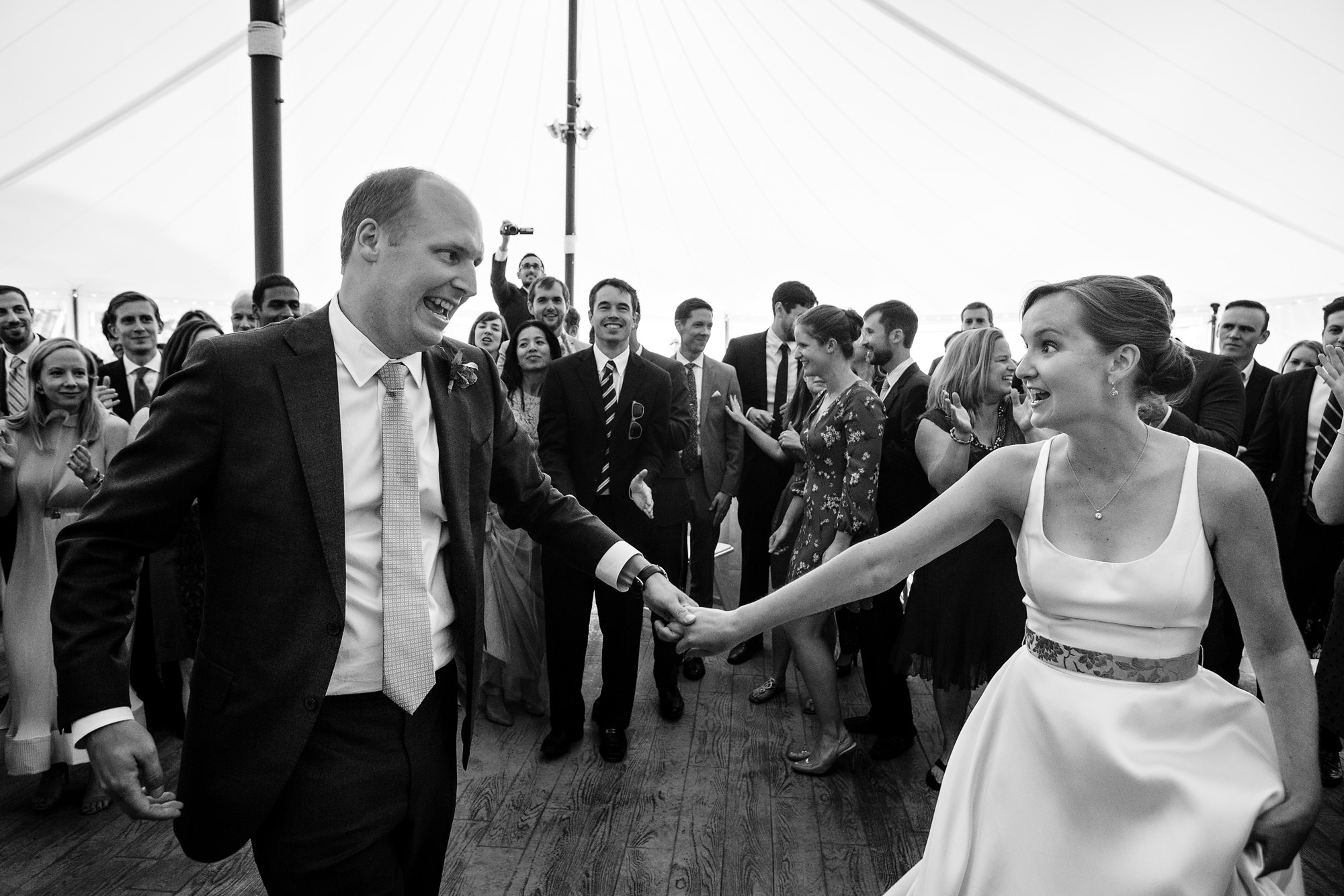 The bride and groom share a dance with their guests at their French's Point wedding