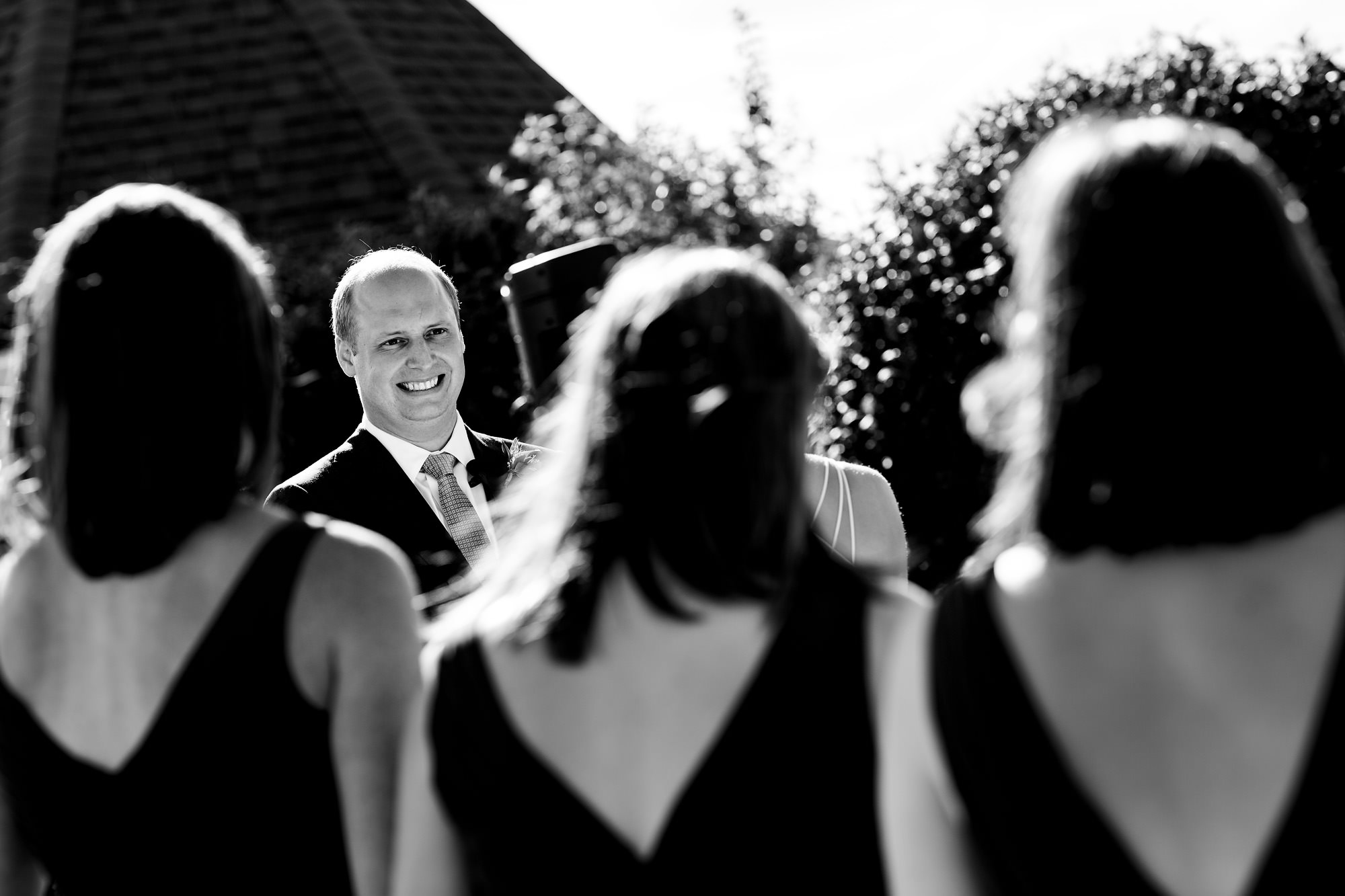 A groom smiles during his wedding ceremony at French's Point