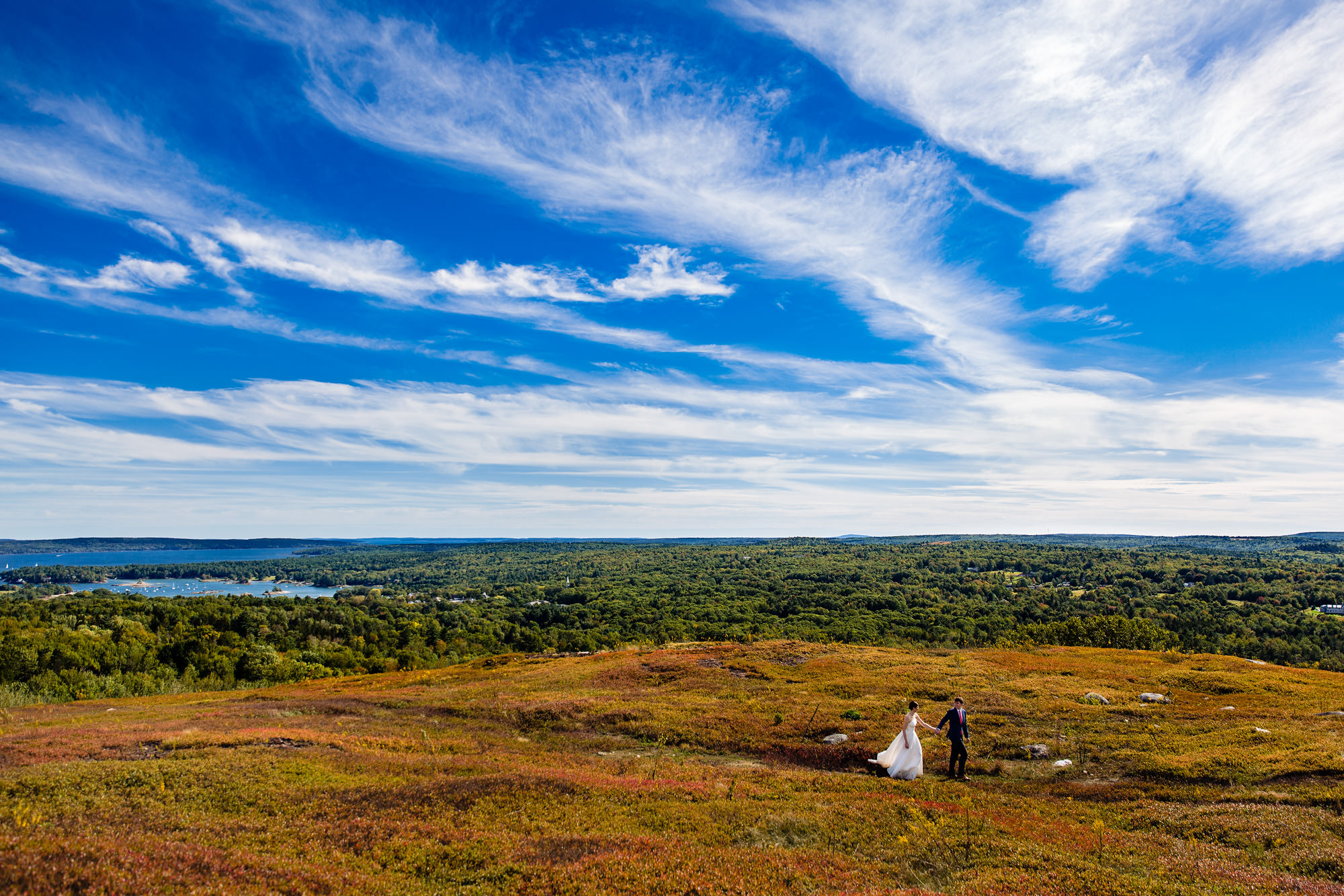 A couple enjoy a scenic view during portraits at their Blue Hill Maine wedding
