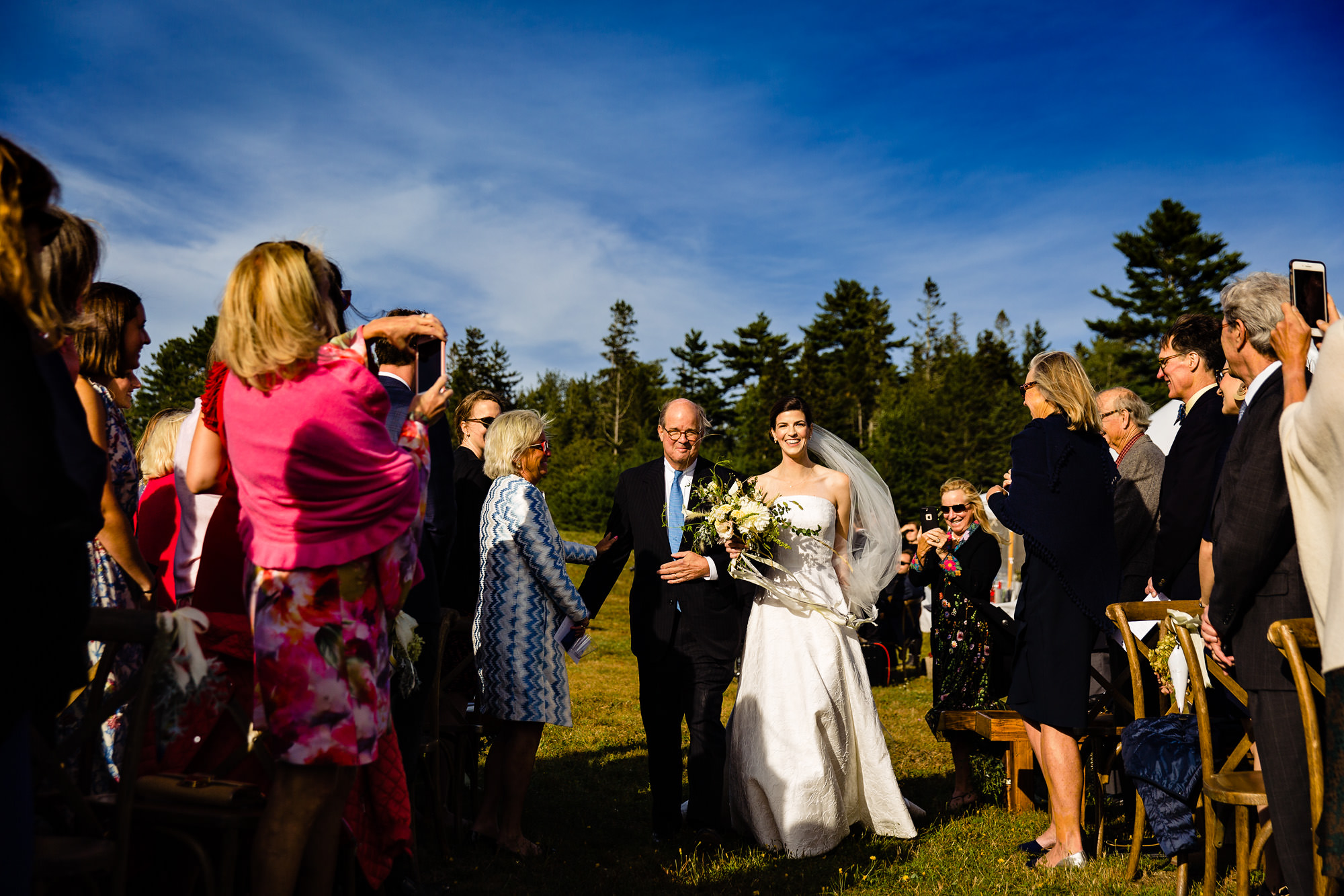 The bride walks down the aisle at her Maine wedding