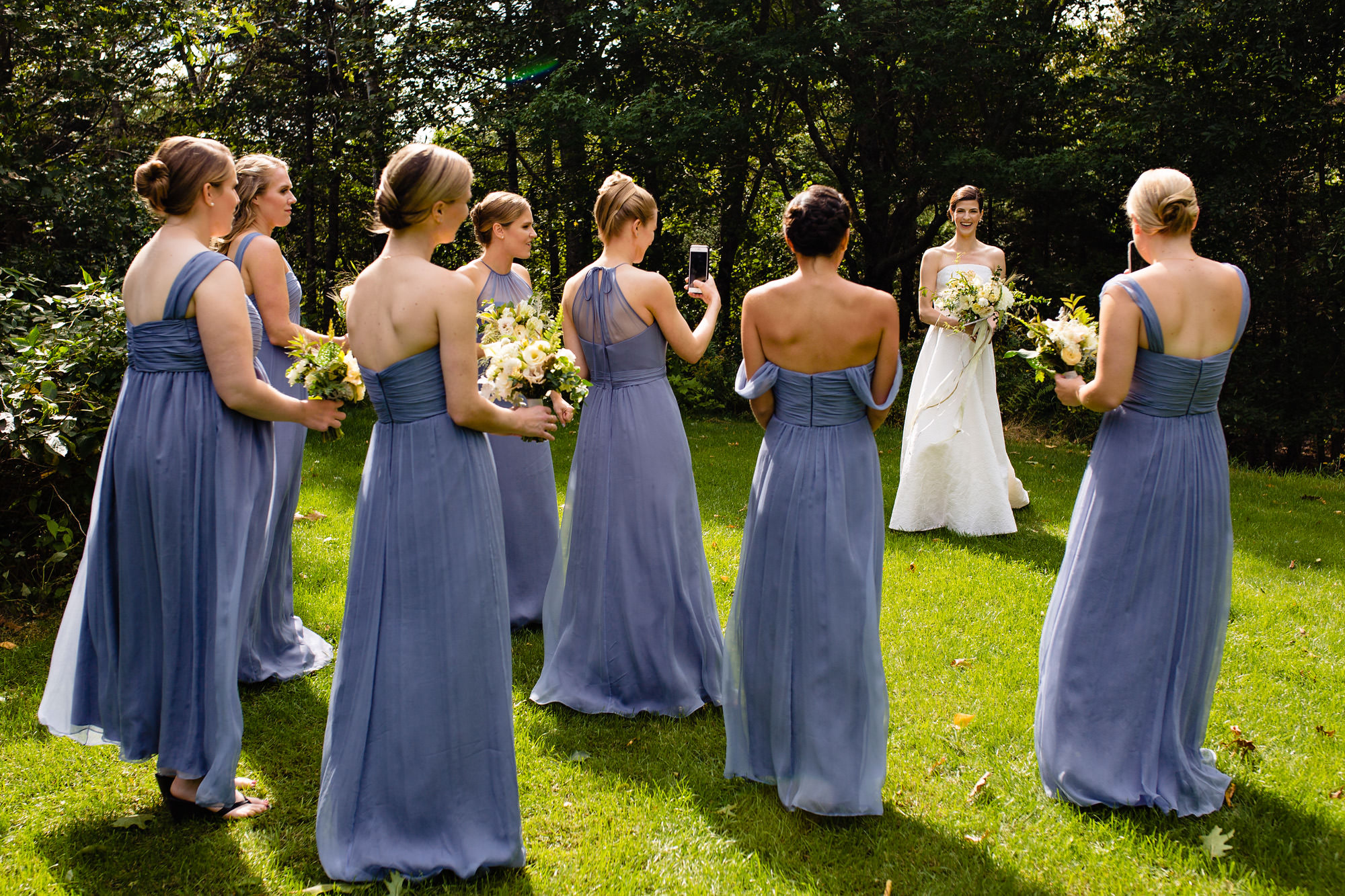 A bride hands out with her bridesmaids at her Maine wedding