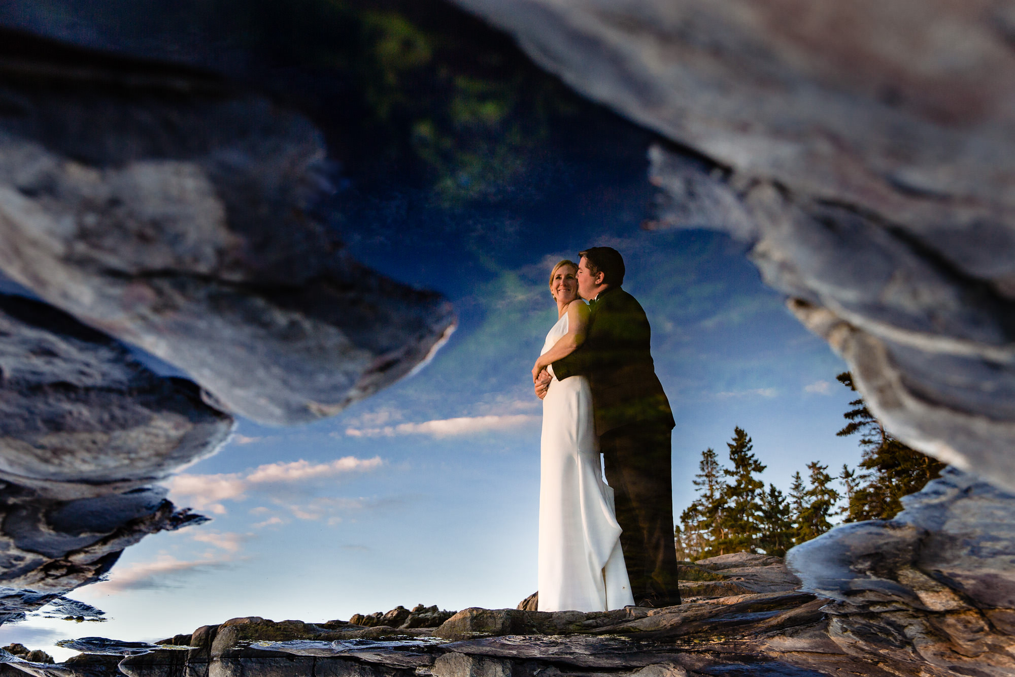 The bride and groom take couples portraits at sunset at the Newagen Inn