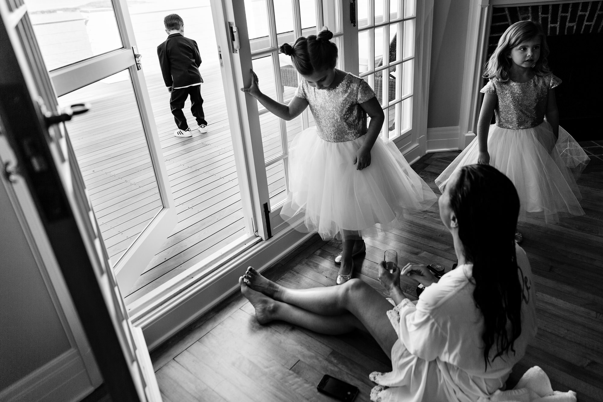 A bride gets ready amongst kids at her Blue Hill Maine wedding