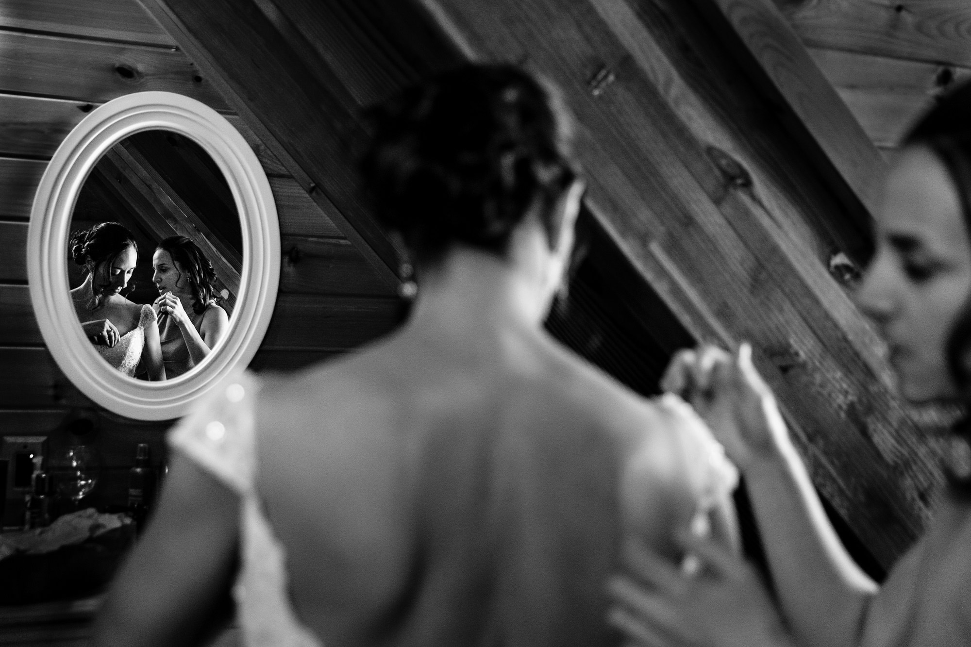 A candid photo of a bride getting ready at Moose Lake Ranch in Maine