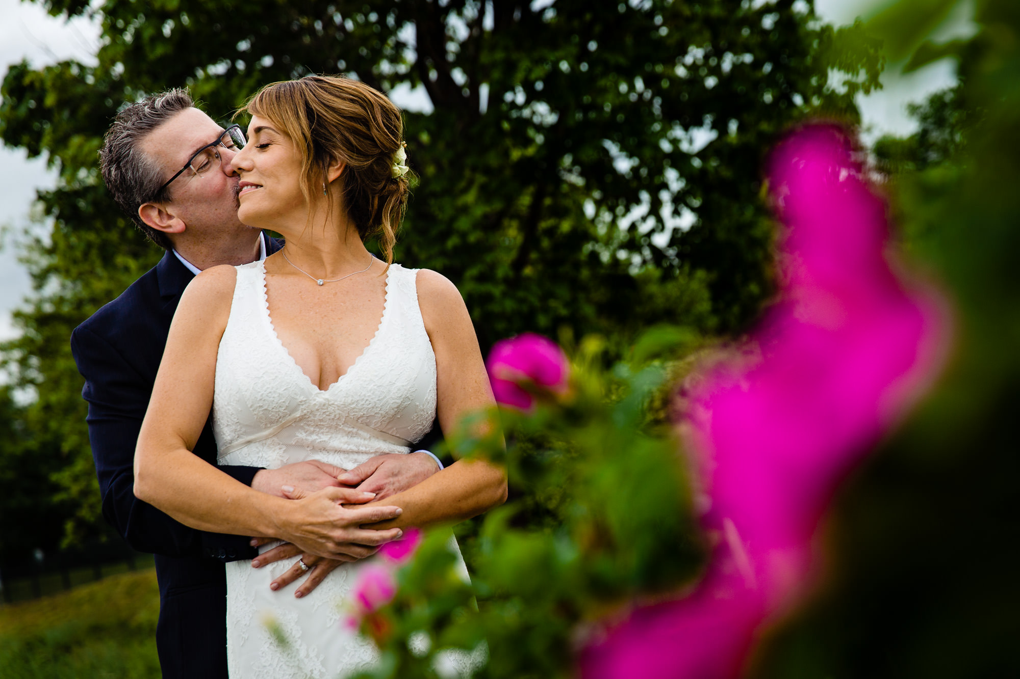 A bride and groom take wedding portraits at the Rockland Breakwater in Maine