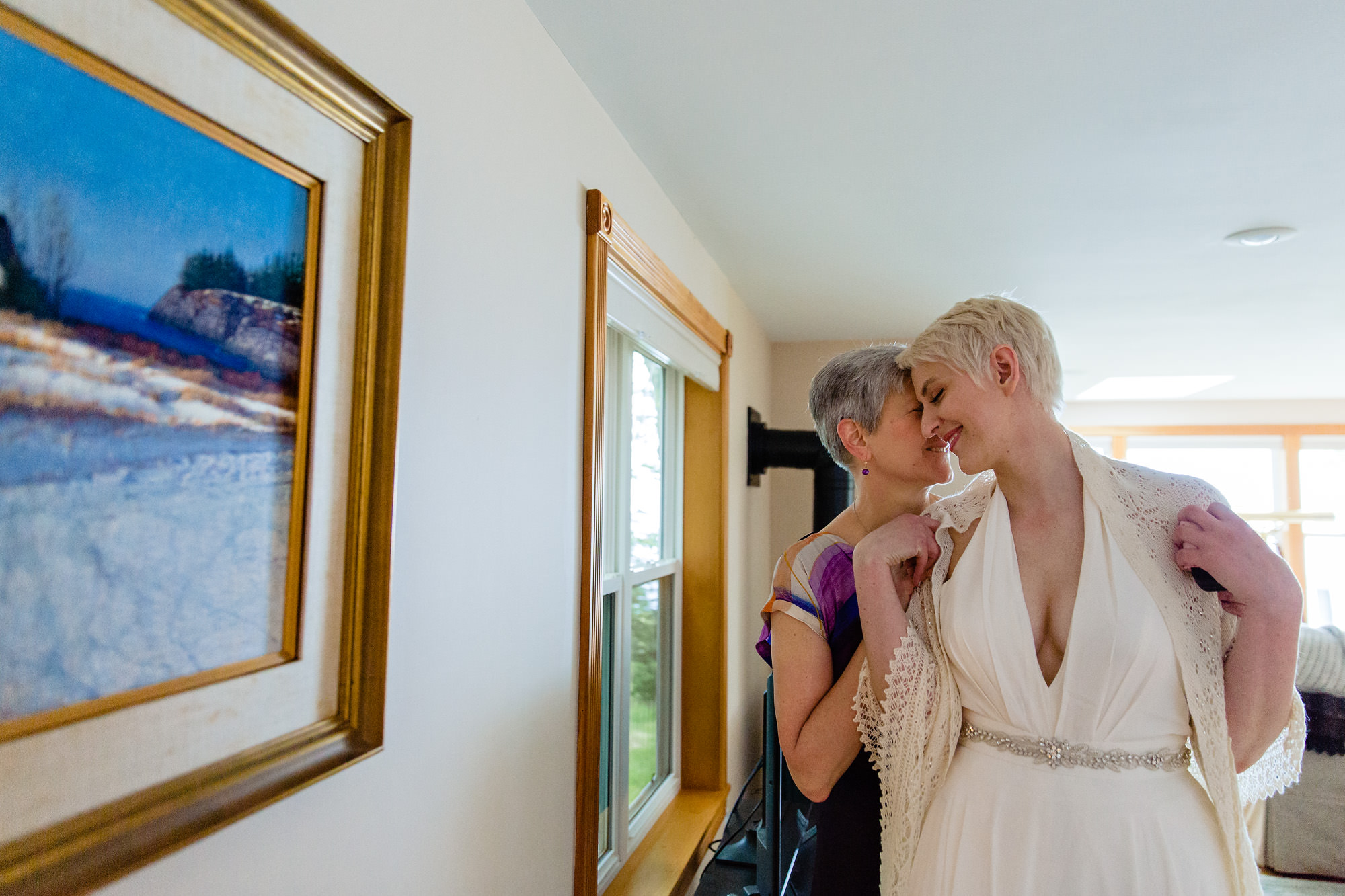 A bride has a quiet moment with her mom at her wedding in Maine