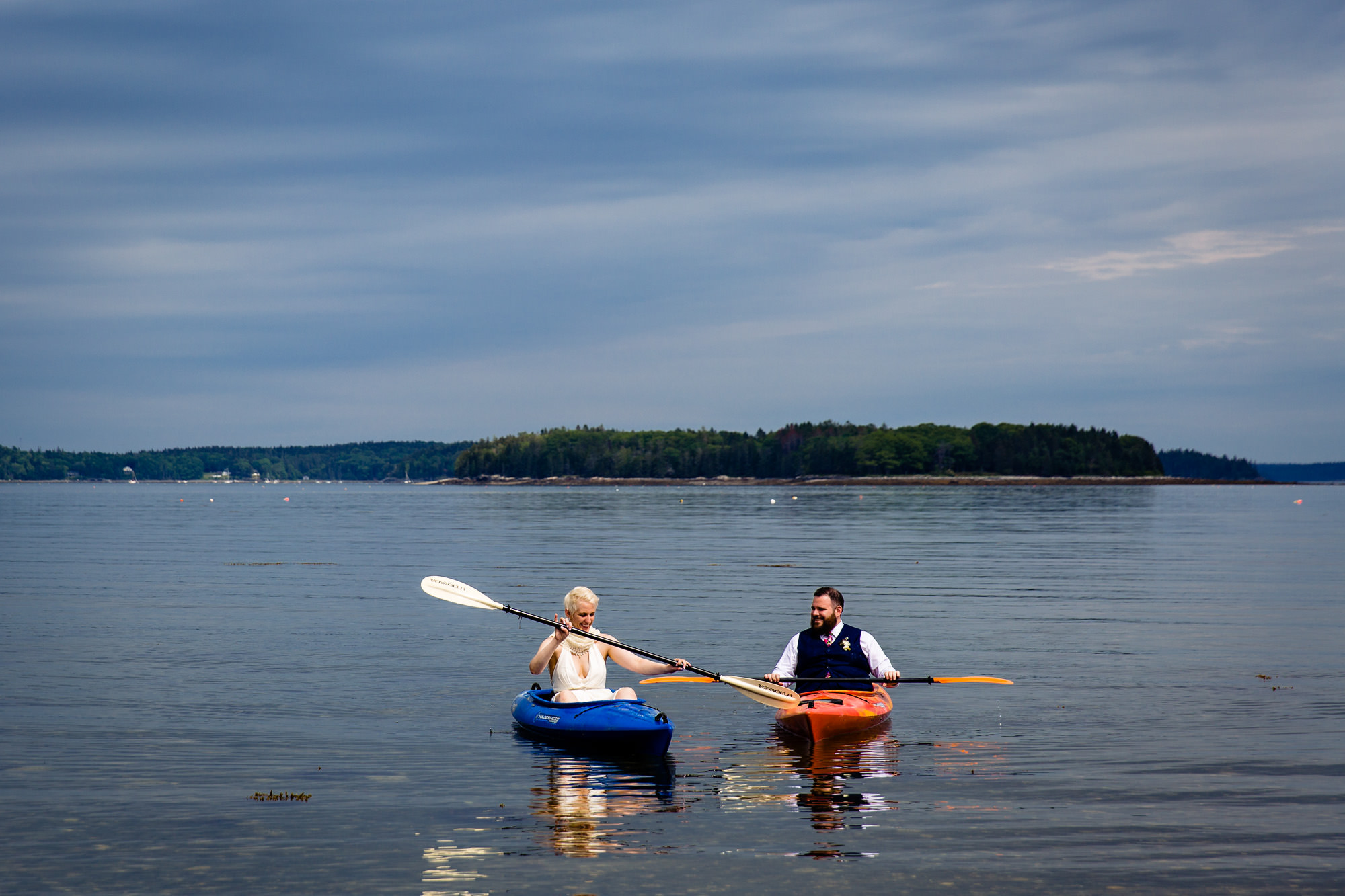The bride and groom kayak at their Hancock Maine coastal wedding