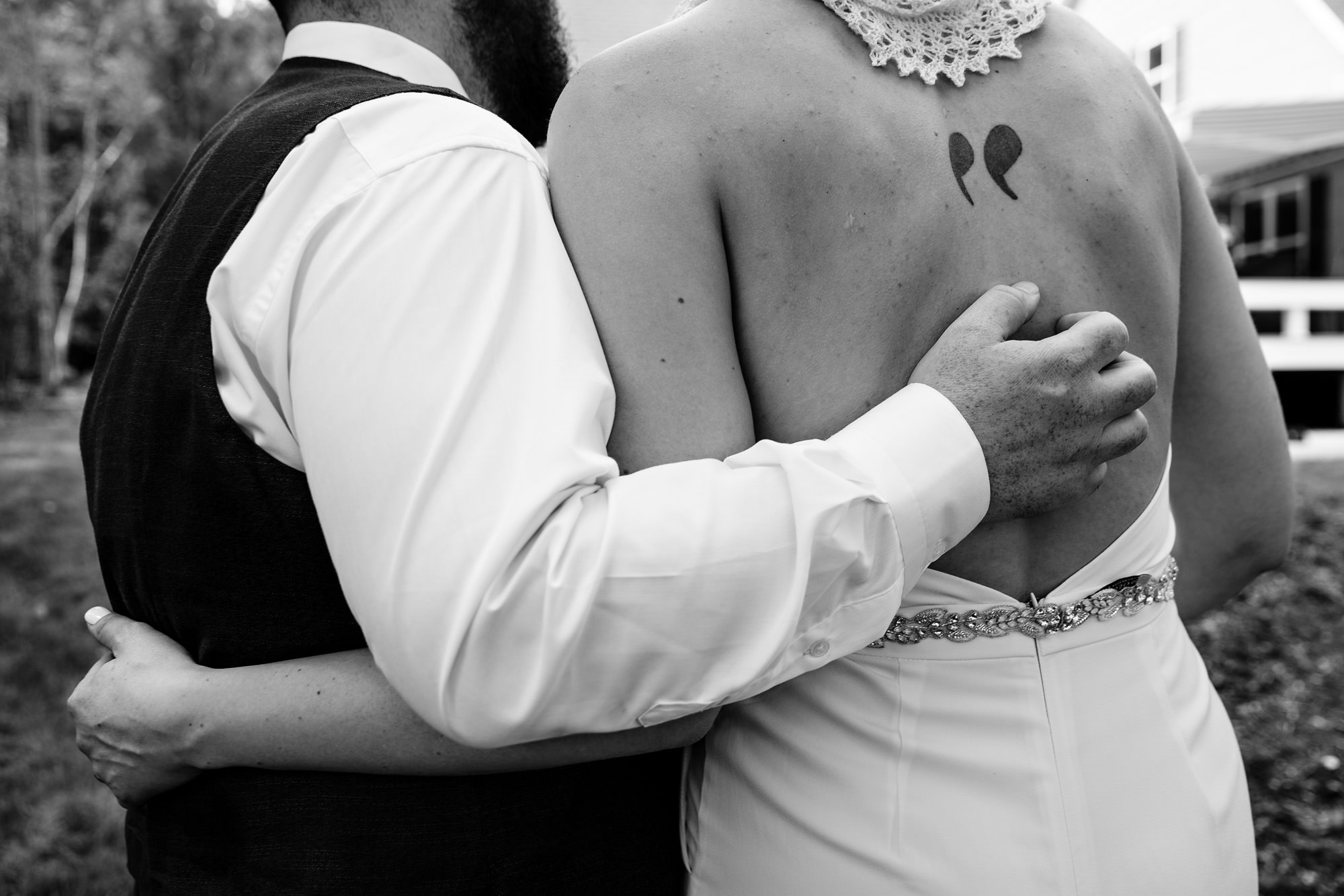 The bride and groom embrace at their private residence wedding