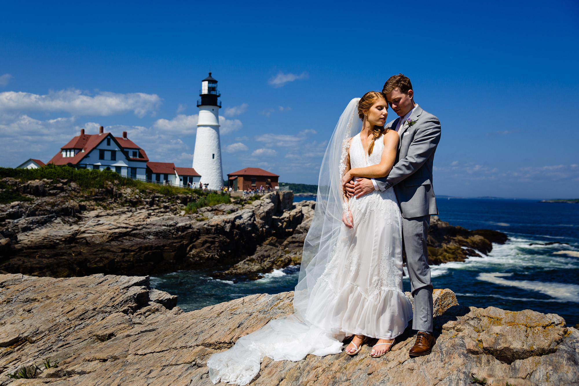A wedding portrait taken at the Portland Headlight in Cape Elizabeth, Maine