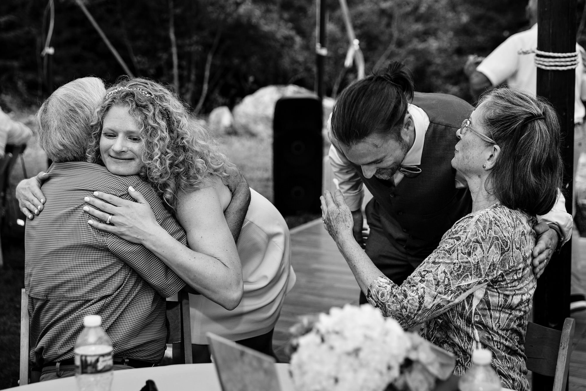 The bride and groom hug friends and family at their Poland Maine wedding