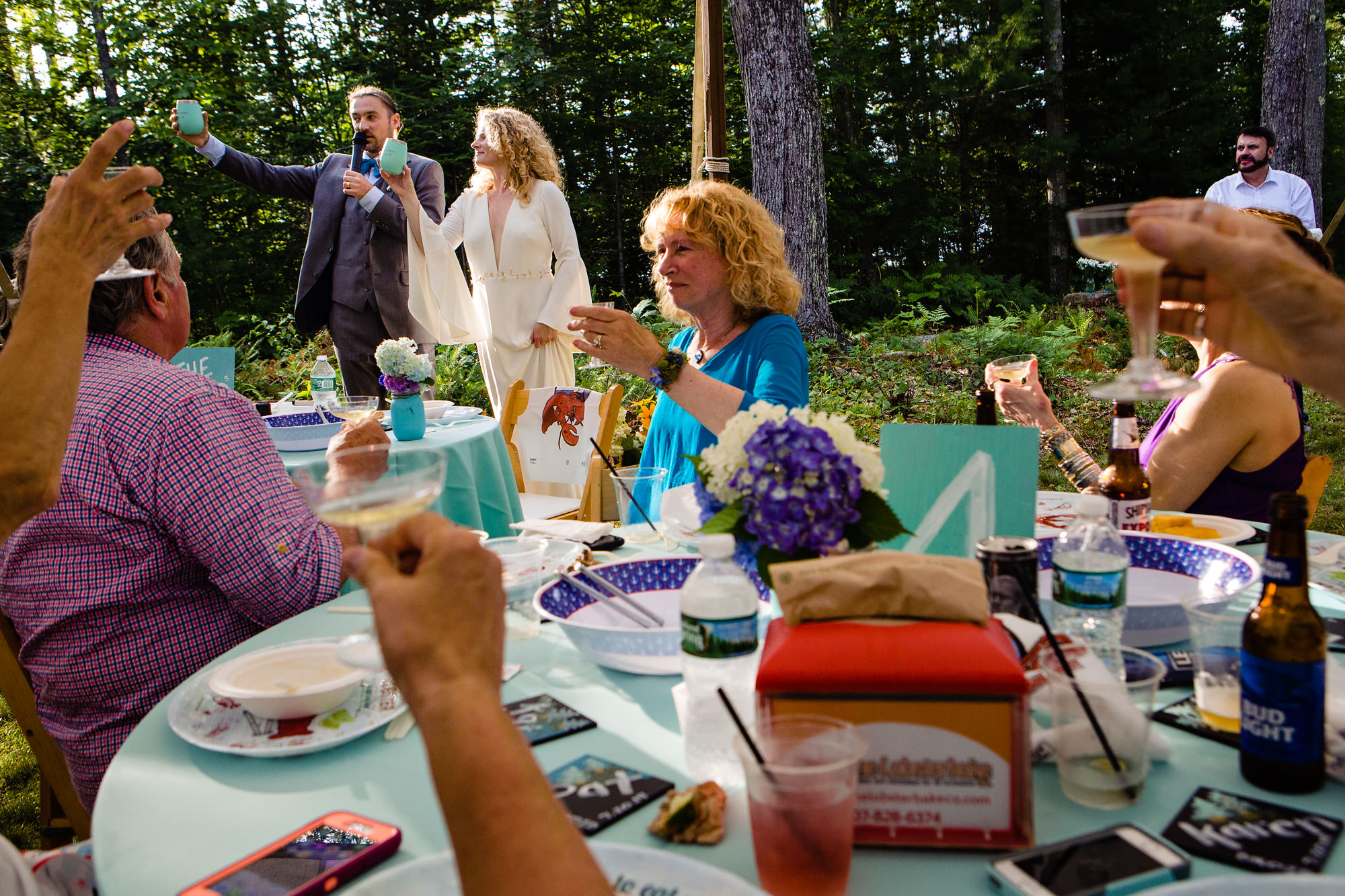 The bride and groom toast to their friends and family at their private residence wedding in Maine