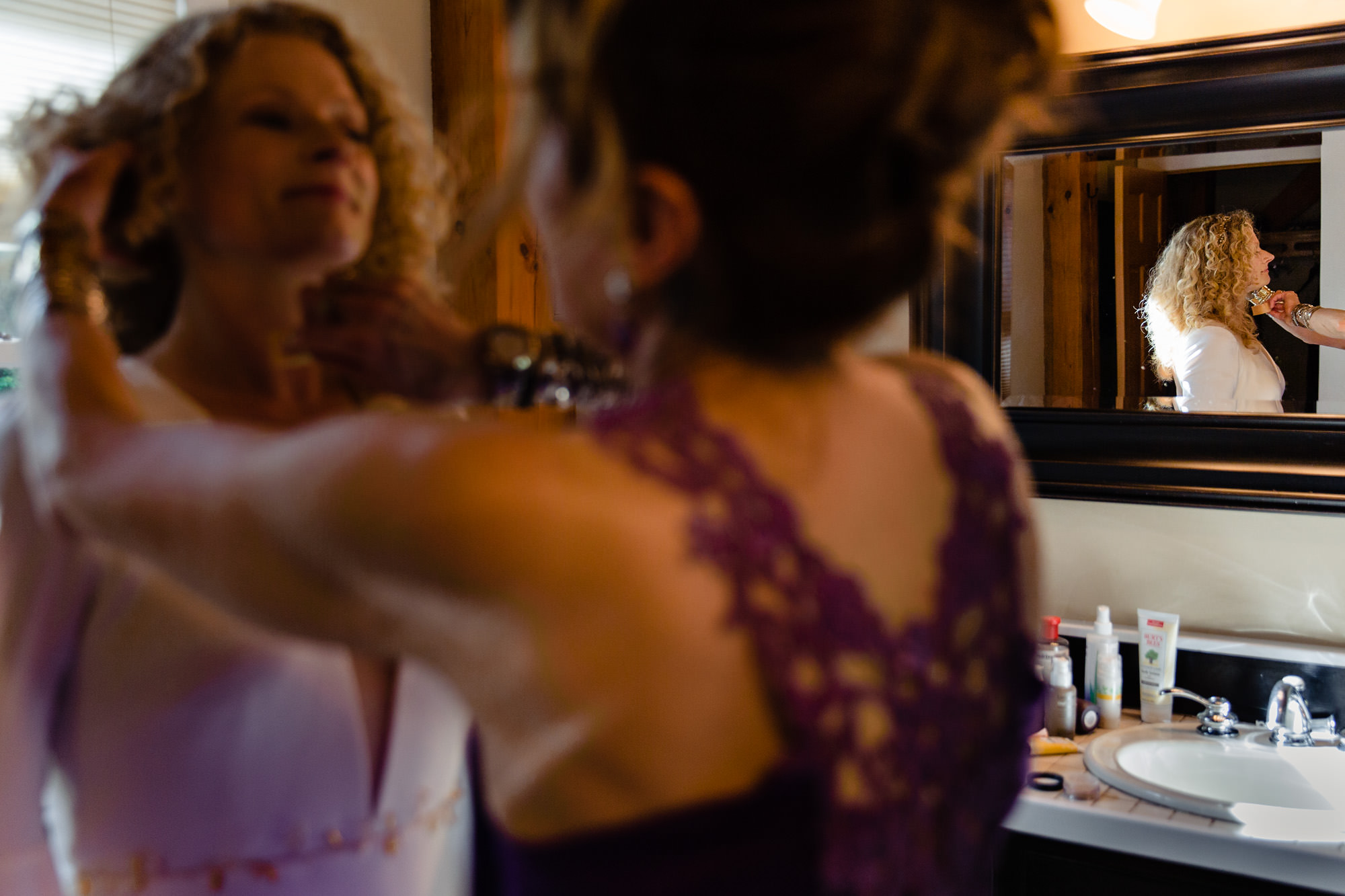 The bride retouches her makeup at her Poland Maine wedding ceremony