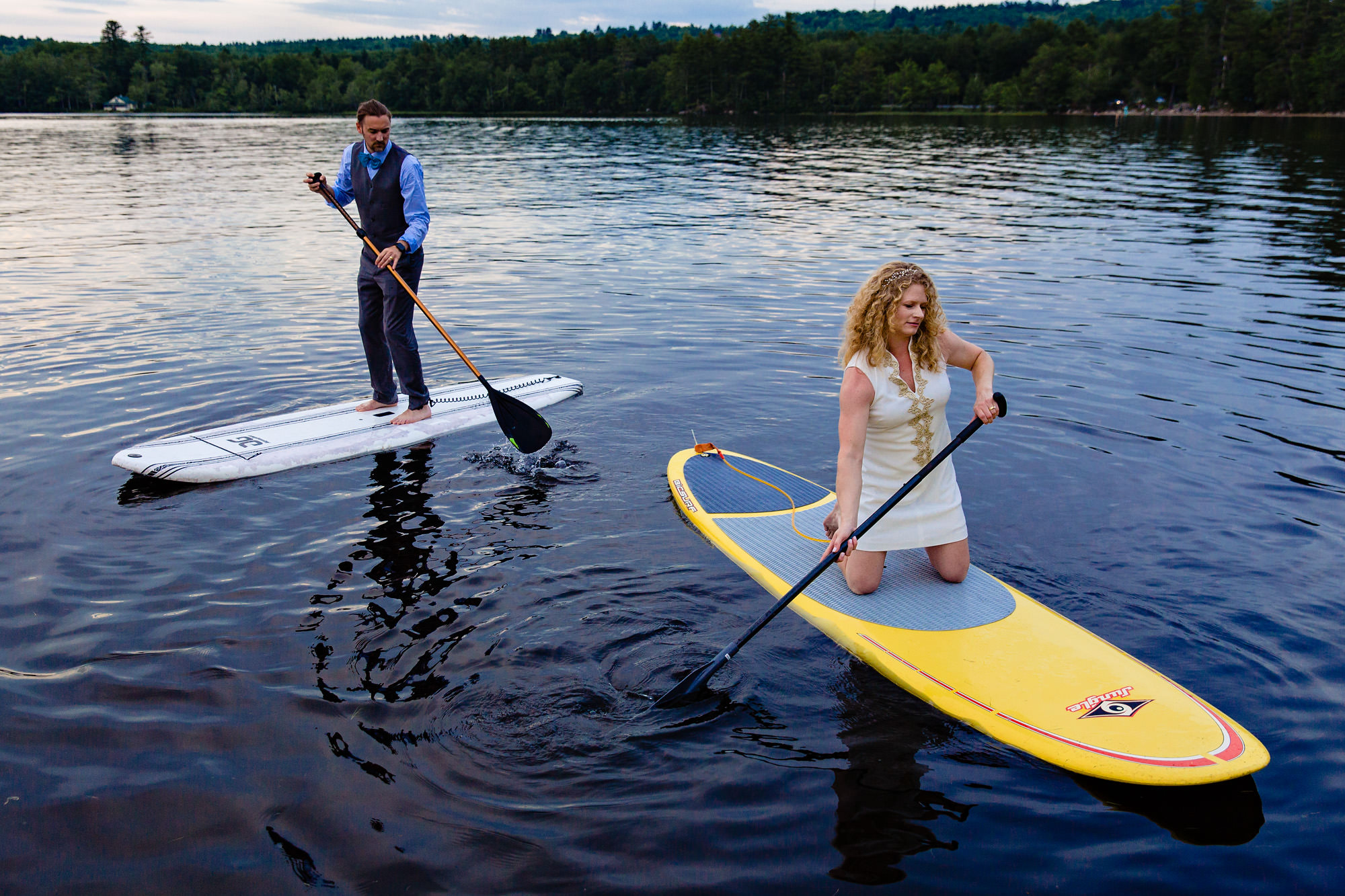 A bride and groom paddleboarded at their Maine lakeside wedding 
