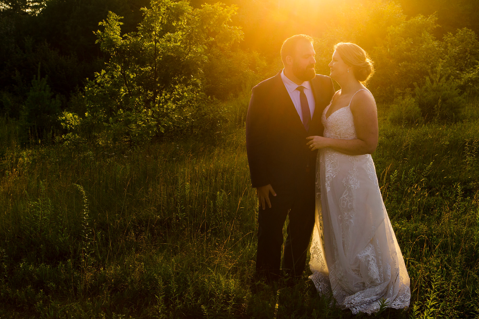 The bride and groom take couples portraits at sunset at French's Point