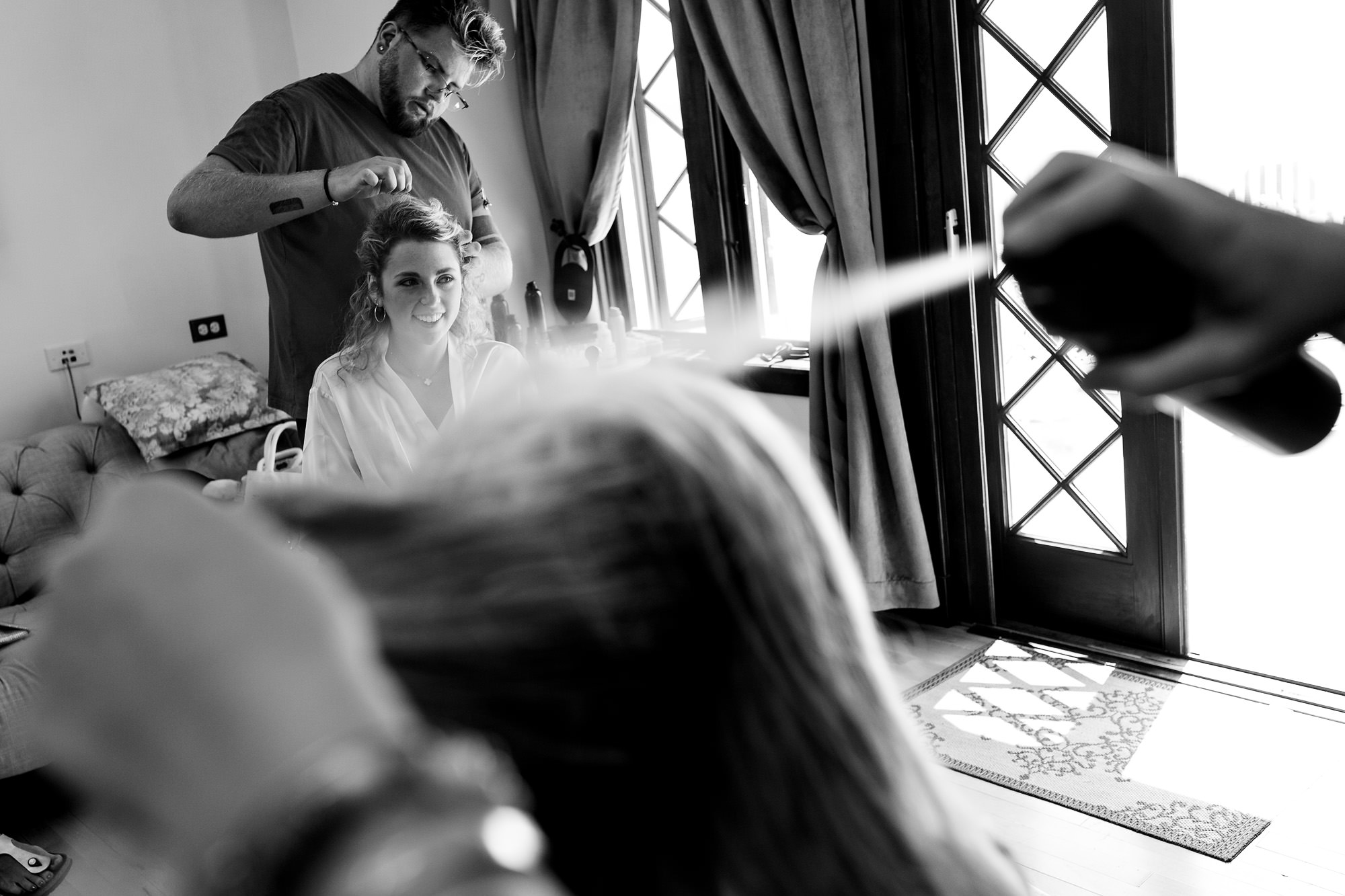 A bride has her hair styled at her French's Point wedding in Maine