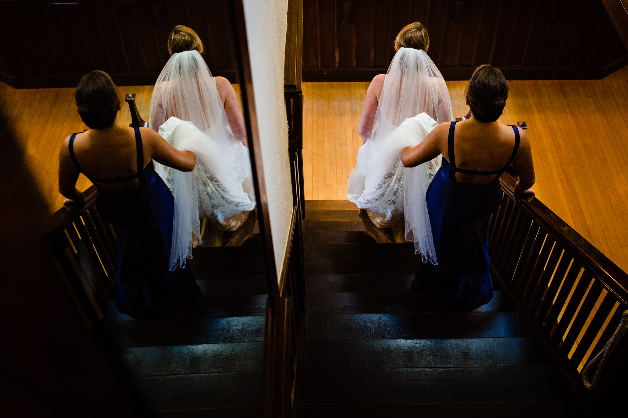 The bride and her maid of honor walk down to the first look at her Maine wedding