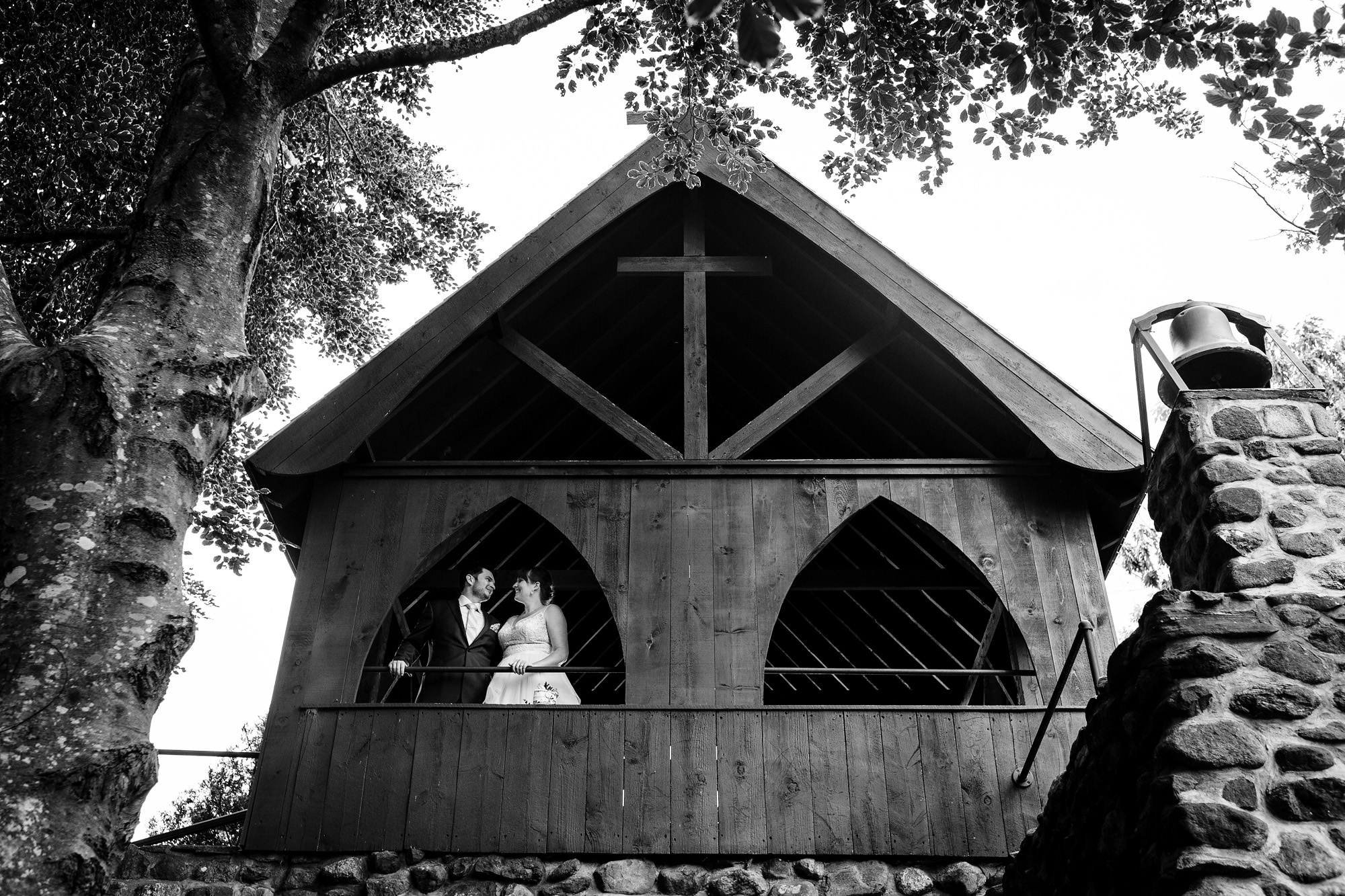 Wedding portraits of the bride and groom taken in the gardens at the Vesper Hill Children's Chapel in Rockport Maine