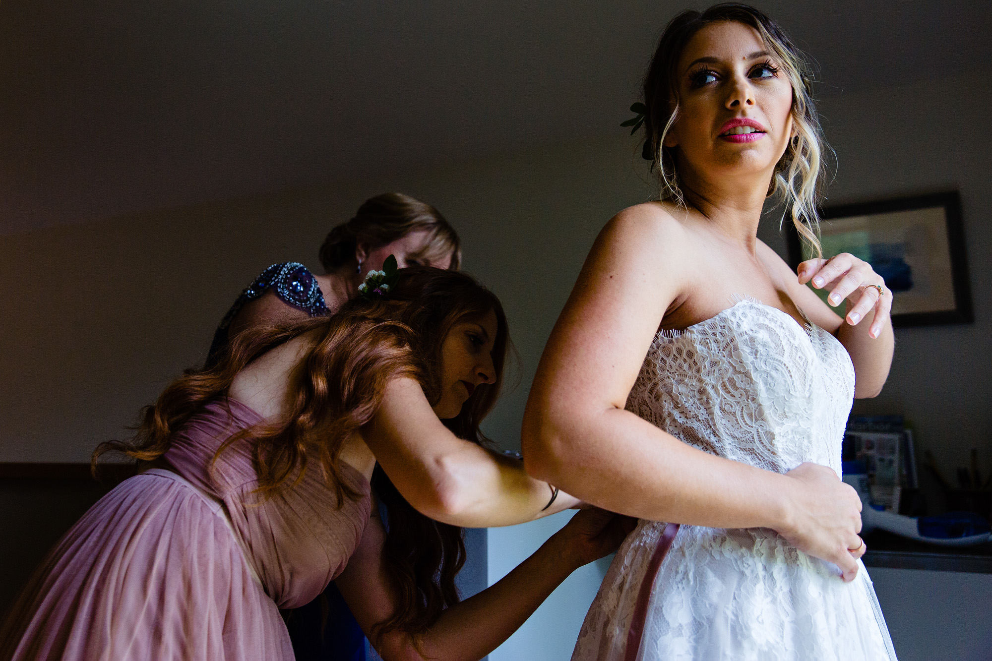 A bride gets dressed at her midcoast Maine wedding