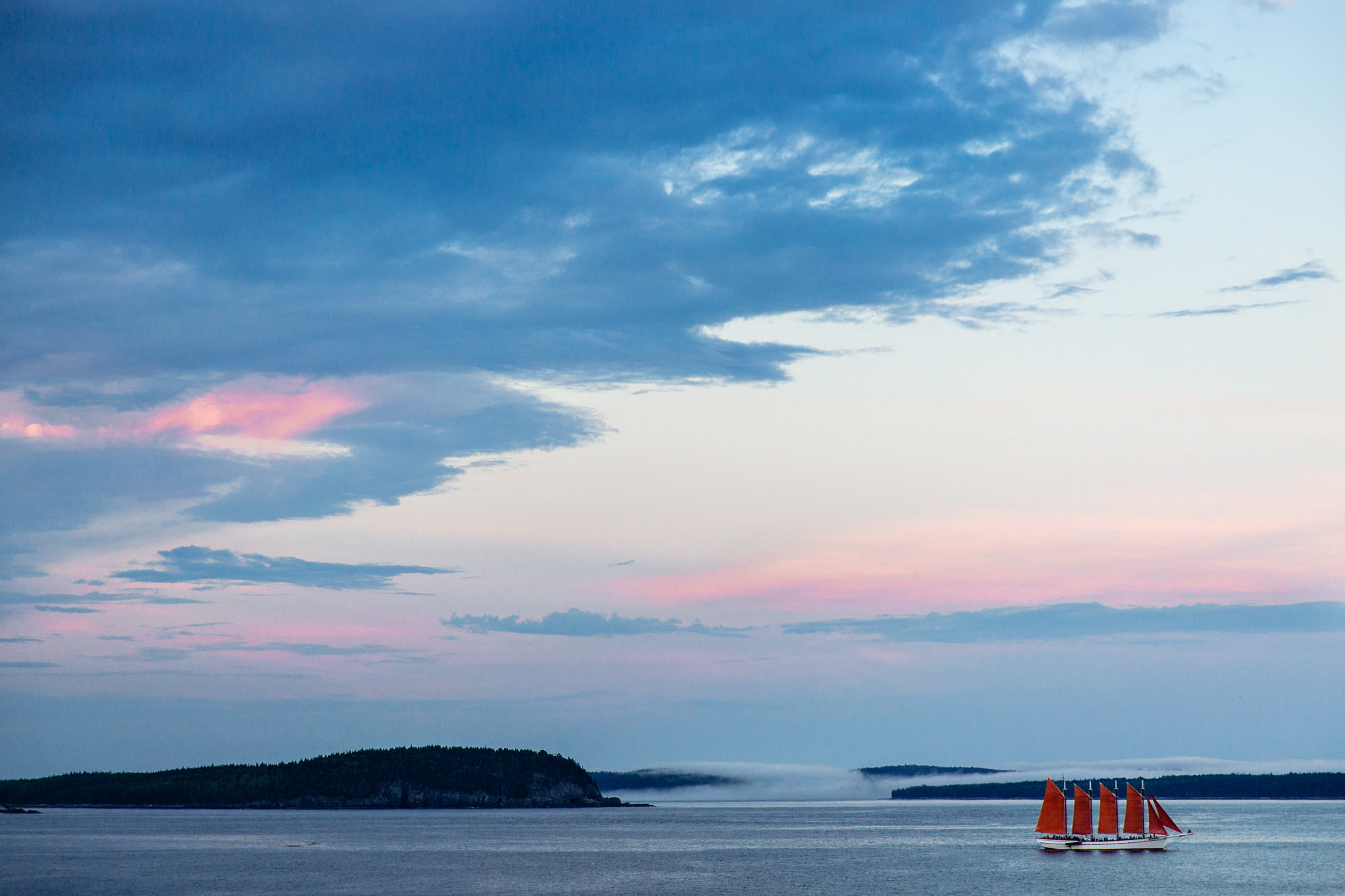 A striking summer sunset in Bar Harbor with the Margaret Todd in the distance.