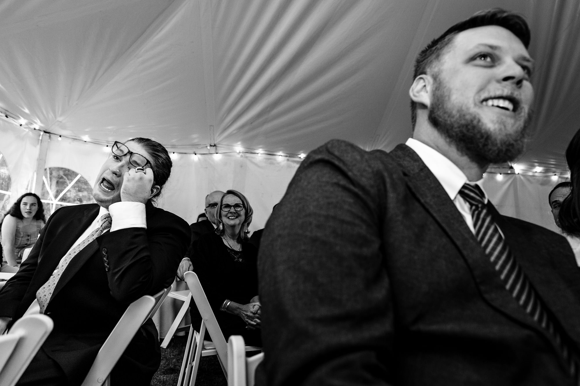 The bride and groom listen to emotional toasts during their Sugarloaf Mountain wedding in western Maine.