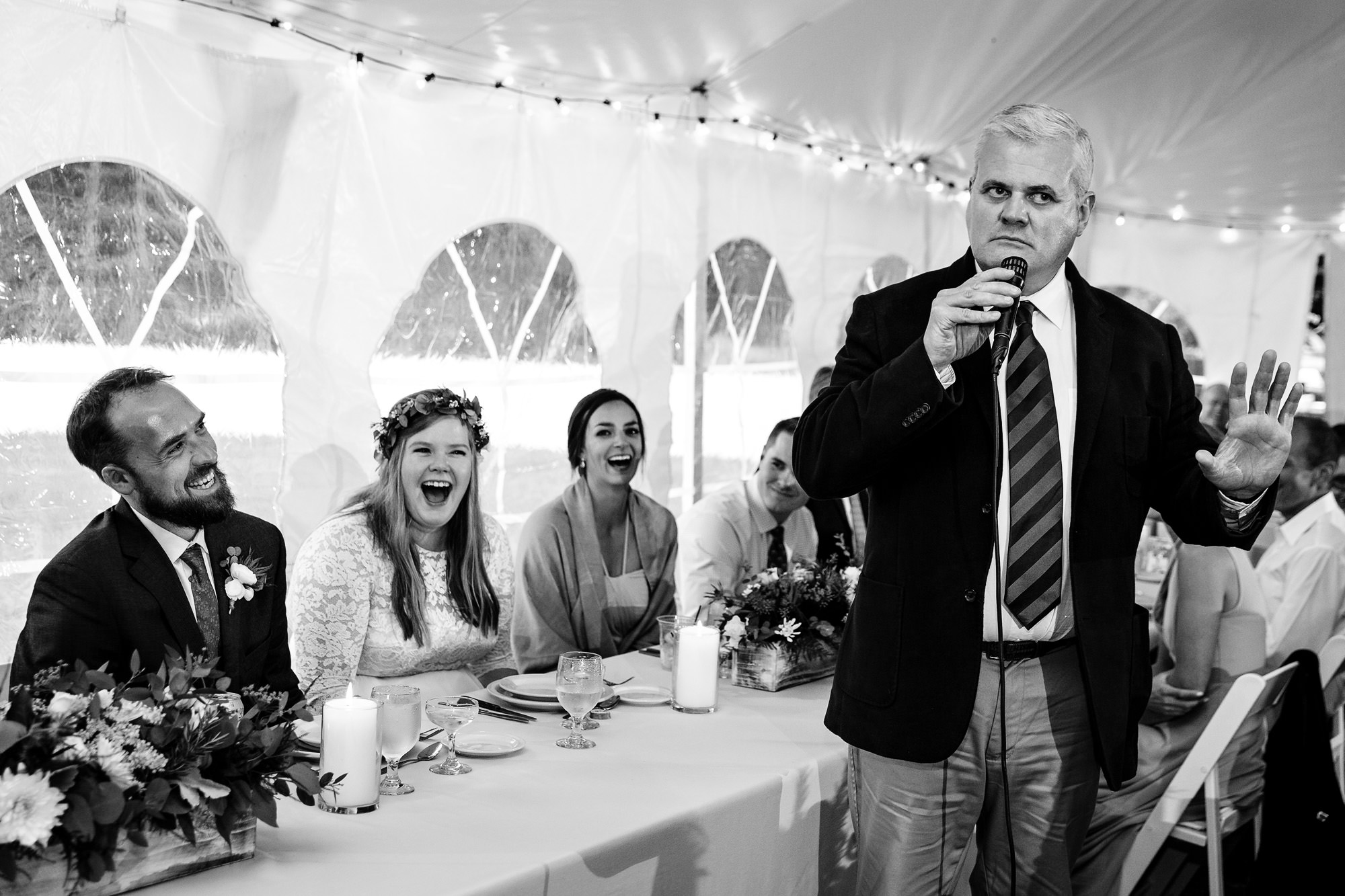 The bride and groom listen to emotional toasts during their Sugarloaf Mountain wedding in western Maine.
