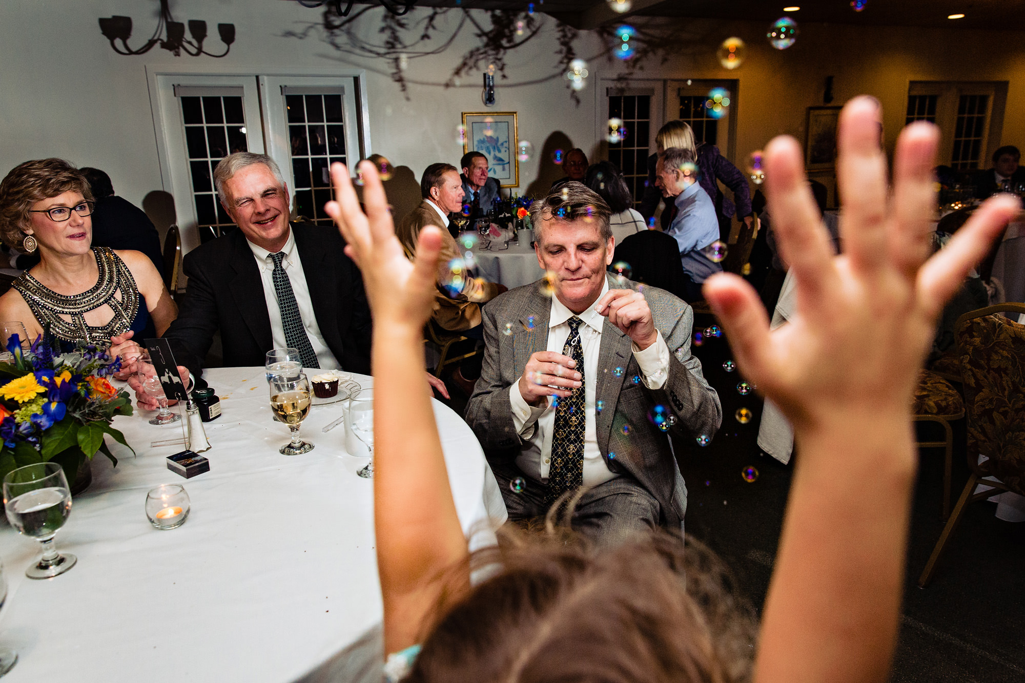 Guests blow bubbles at a Freeport Maine wedding reception