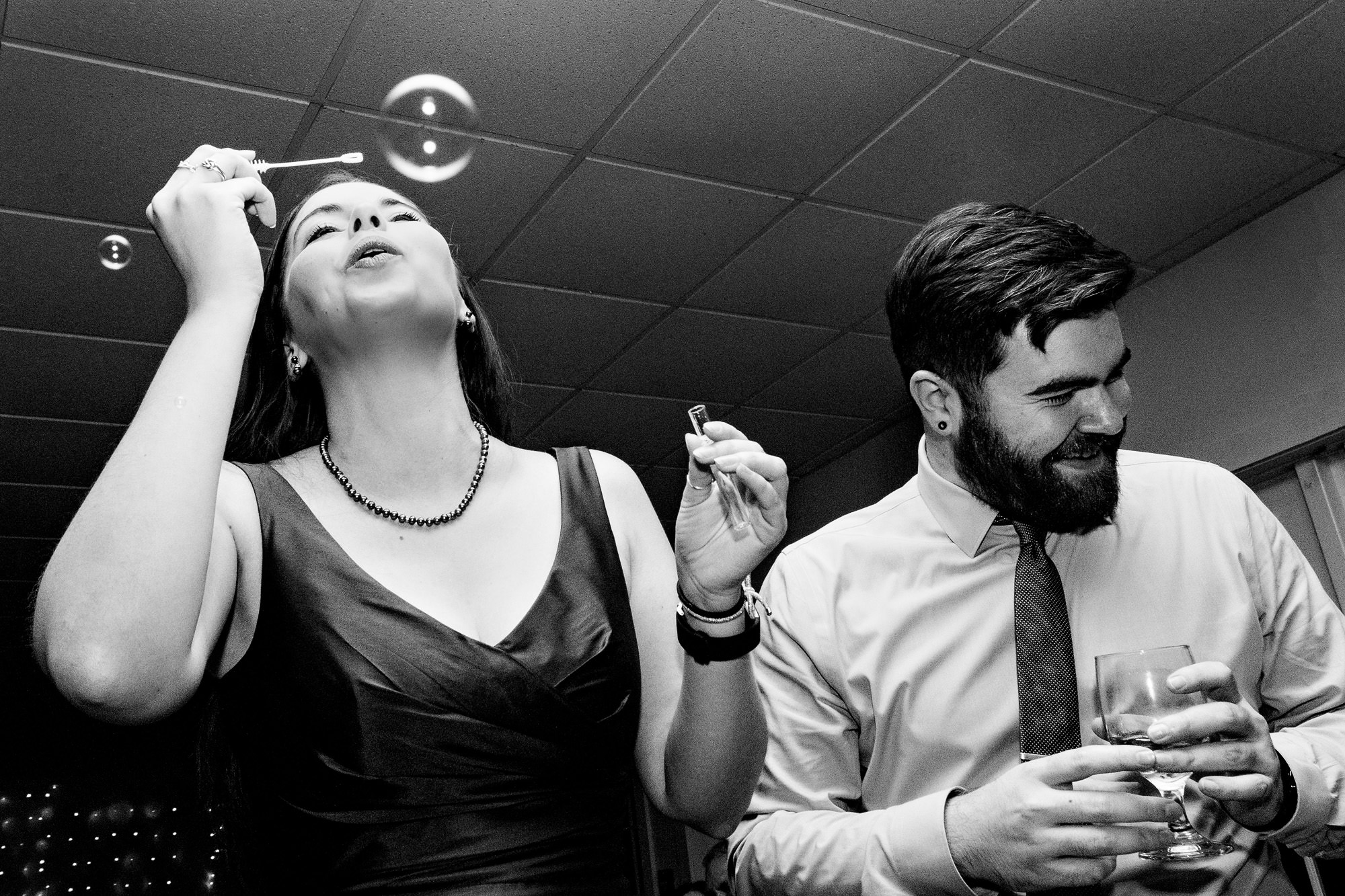 Guests blow bubbles at a Freeport Maine wedding reception