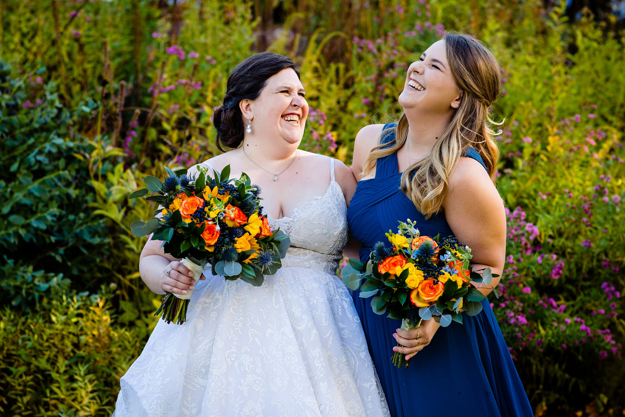 The bride laughs with her sister at her Harraseeket wedding in Maine