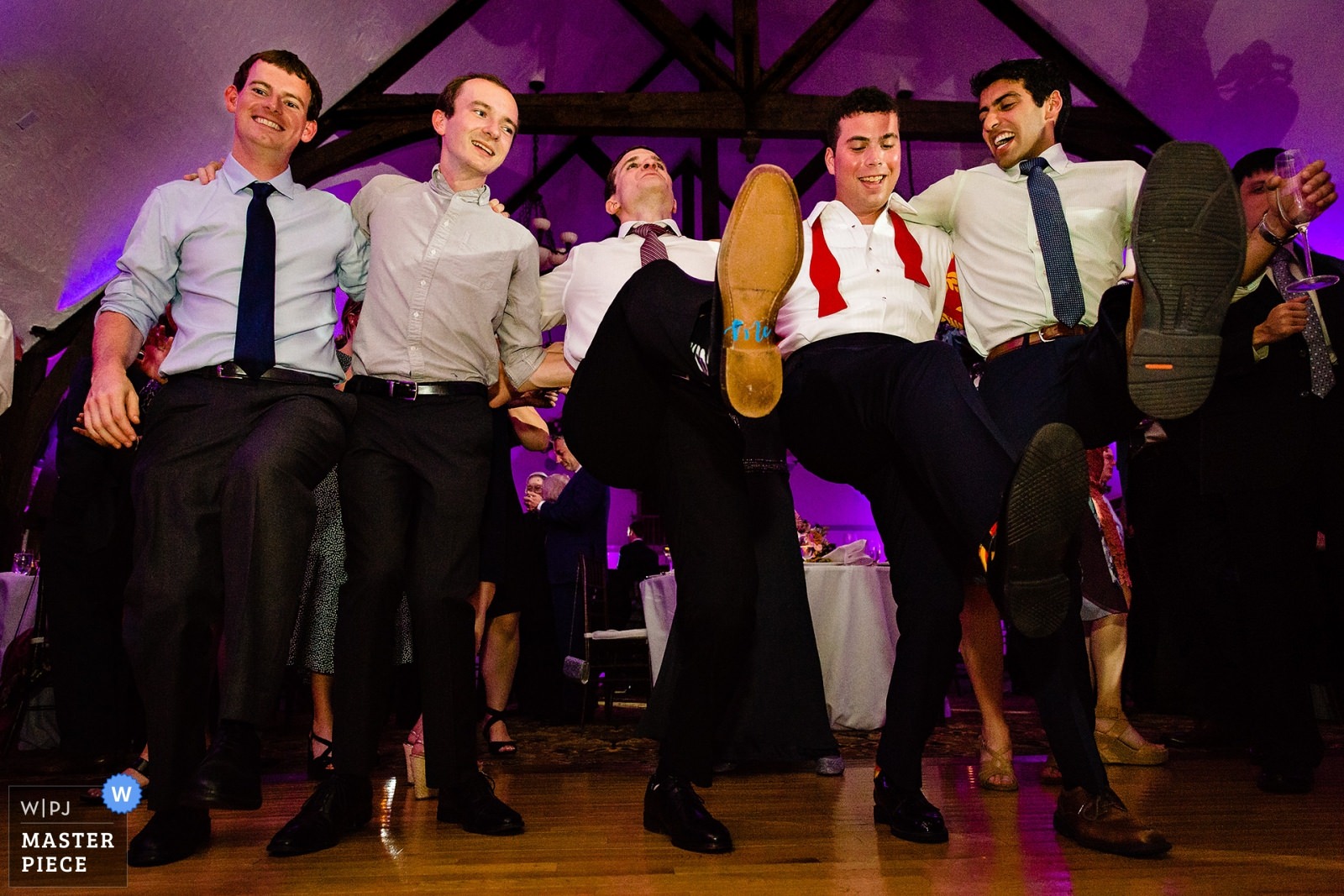 A groom dances with his friends at his Bar Harbor Club wedding