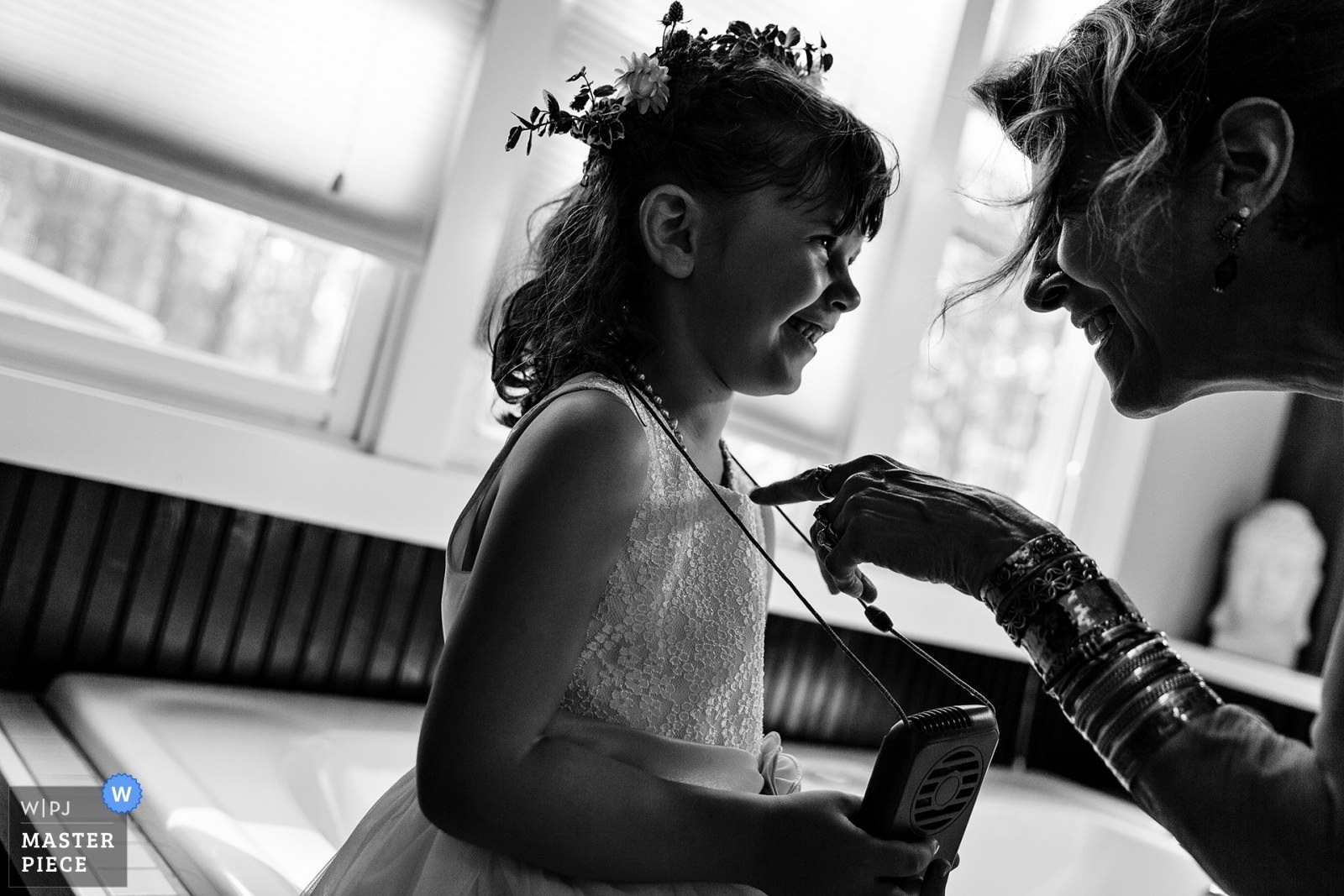 A guest plays around with a flower girl at a western Maine wedding