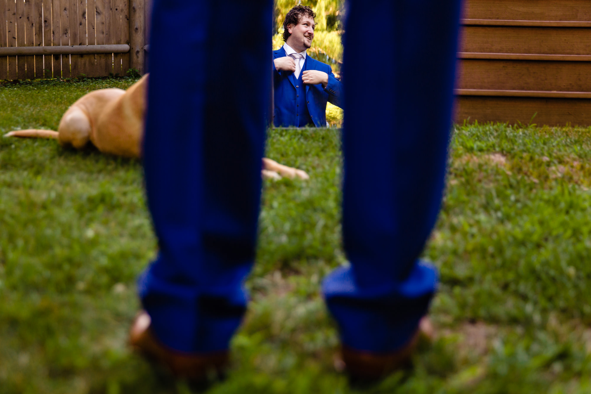 A groom gets dressed at his backyard Brunswick Maine elopement
