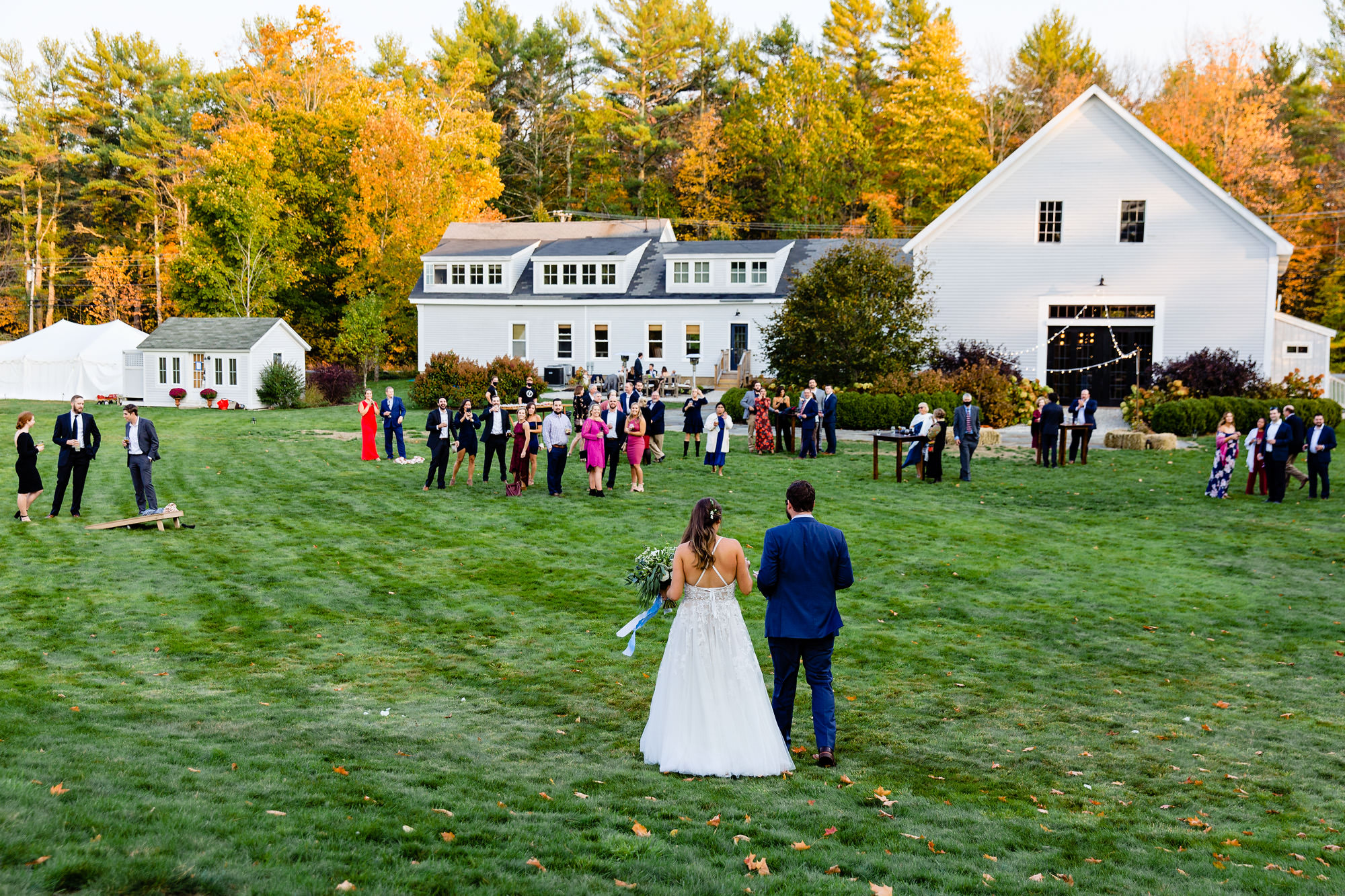 A cocktail hour at a wedding at a farm in Maine