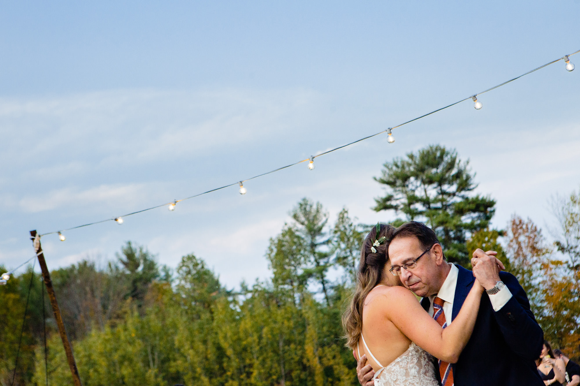 The bride shares a first dance with her father at her wedding in Maine