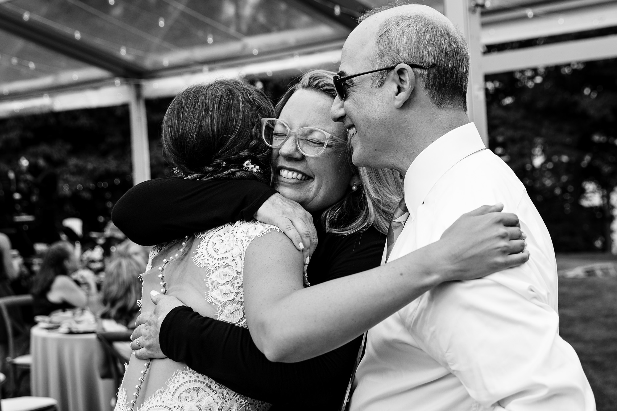 People hug at a wedding at Marianmade Farm in Maine