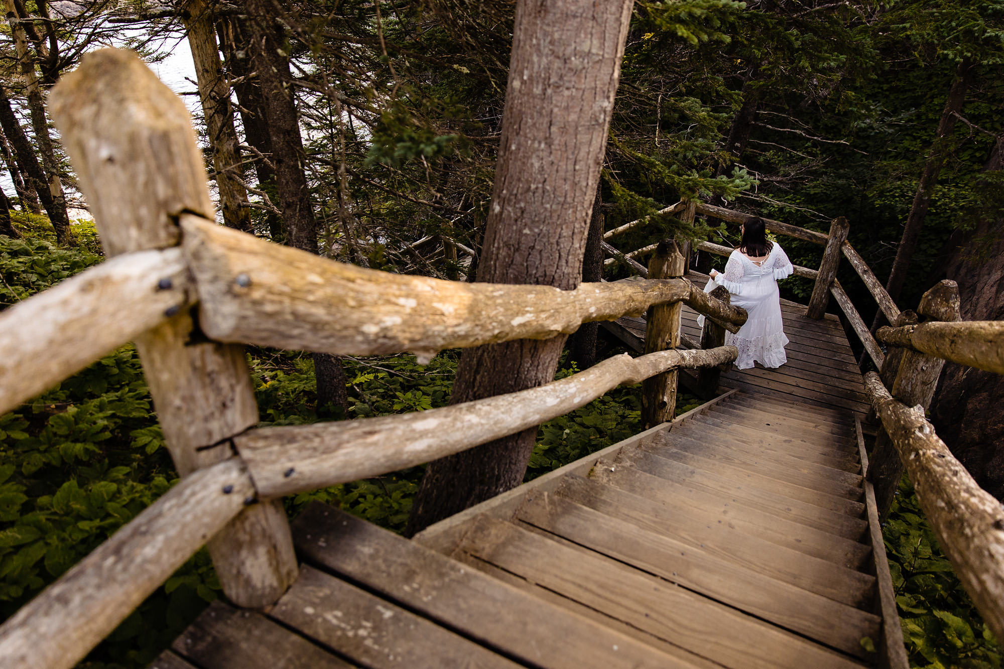 A bride walks down to the beach for her first look at her elopement in Acadia