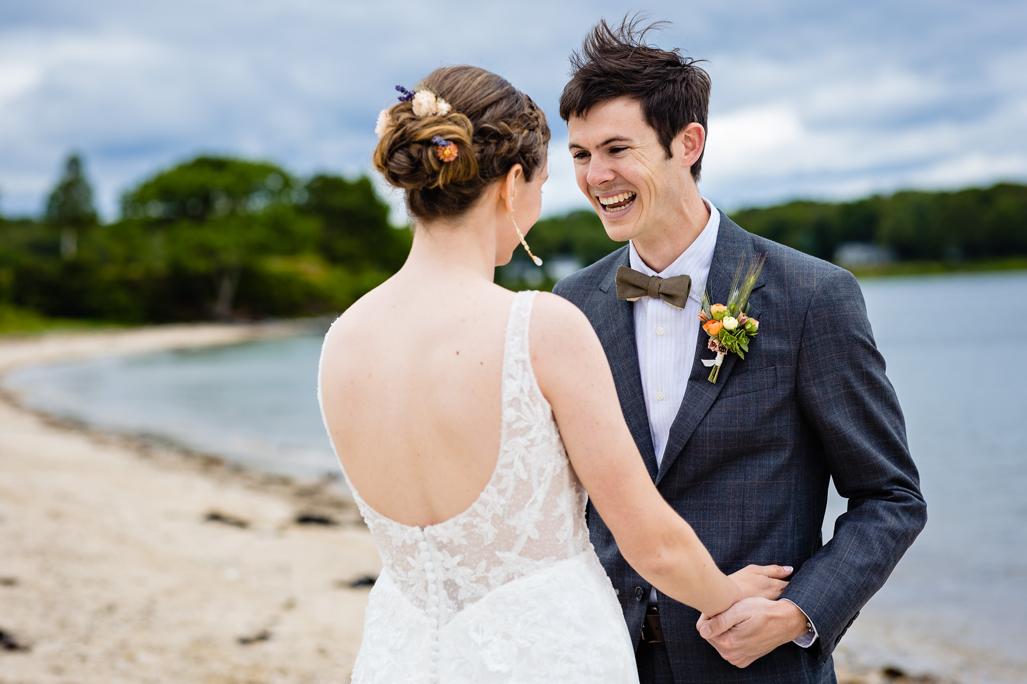 A stunning first look prior to a wedding on a beach on Chebeague Island, Maine
