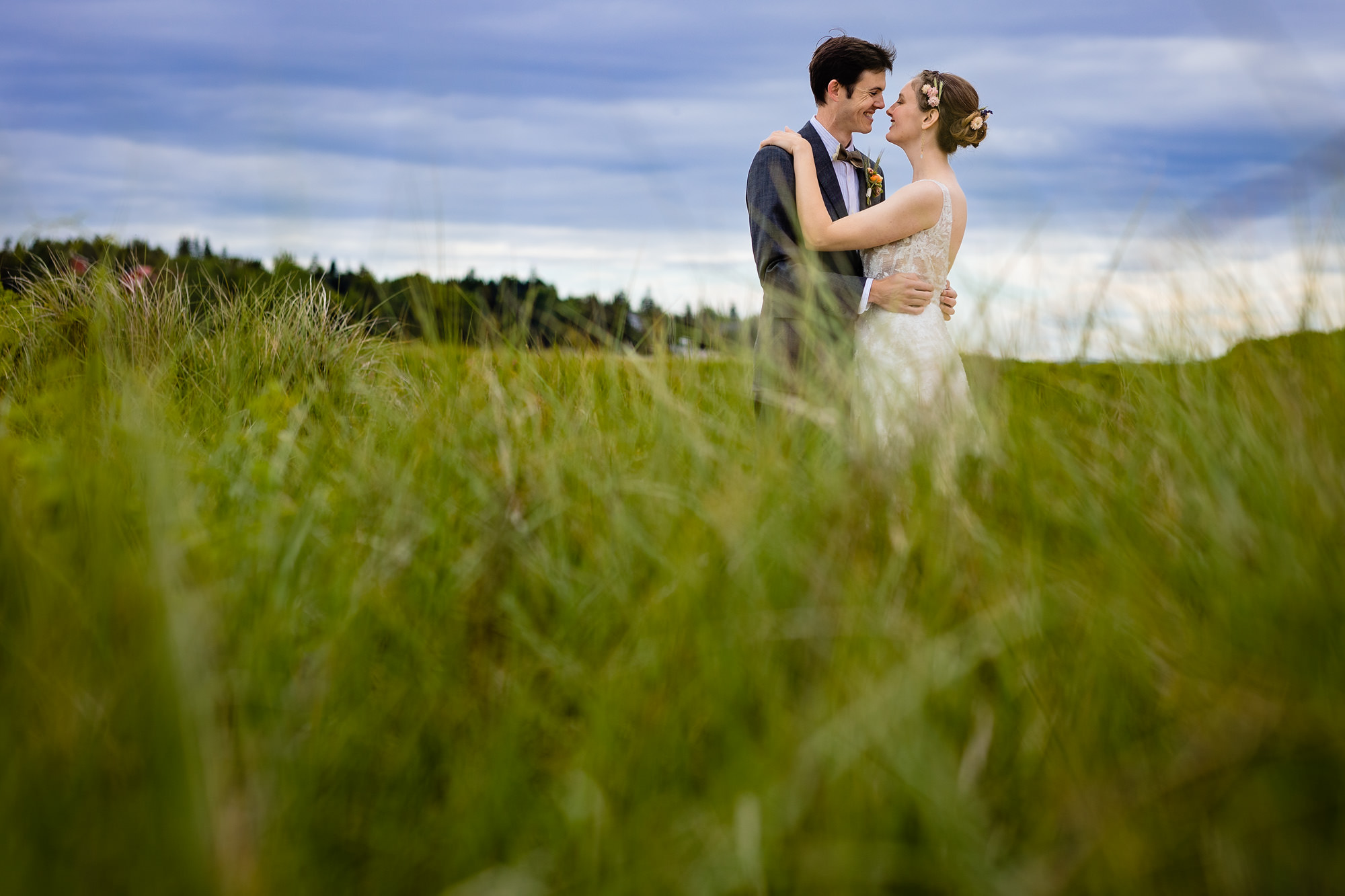 A stunning first look prior to a wedding on a beach on Chebeague Island, Maine